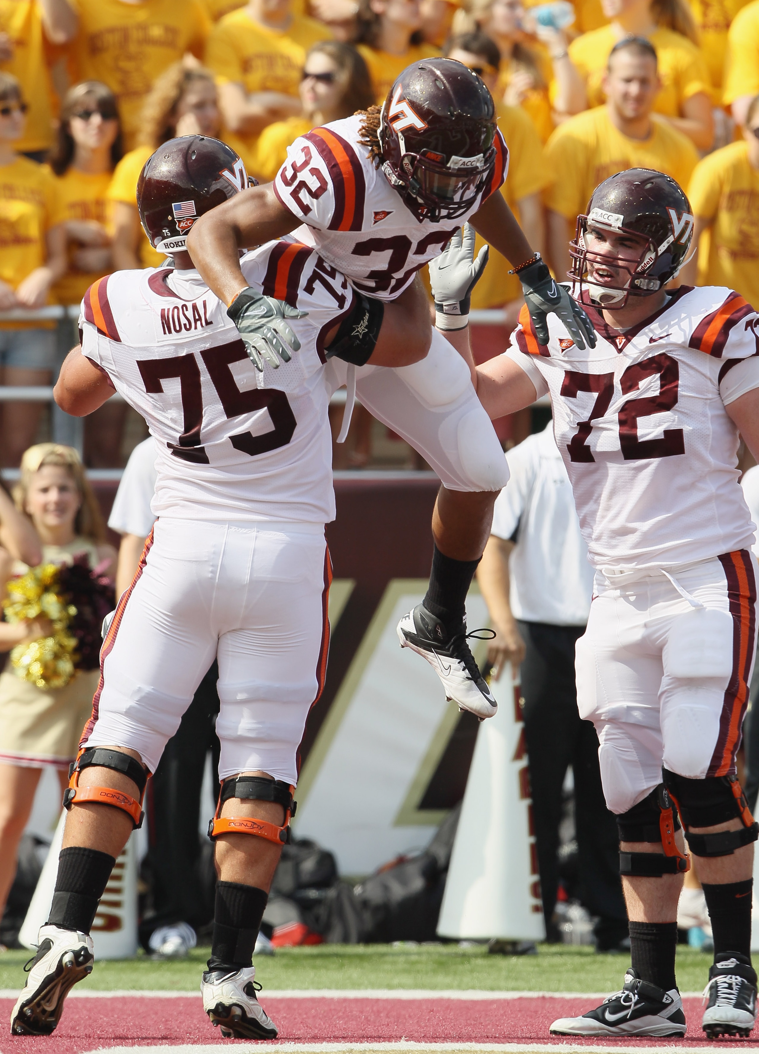 CHESTNUT HILL, MA - SEPTEMBER 25:  Darren Evans #32 of Virginia Tech Hokies is congratulated by teammates Greg Nosal #75 and Andrew Lanier #72 after Evans scored a touchdown in the first half against the Boston Collge Eagles on September 25, 2010 at Alumn
