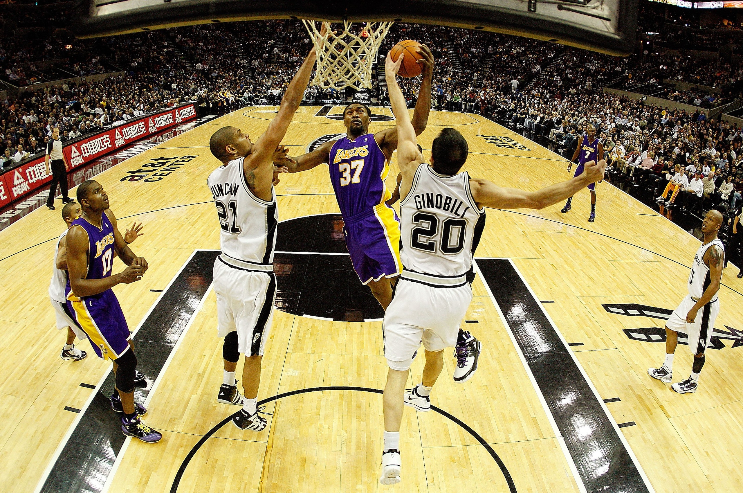 SAN ANTONIO - JANUARY 12: Forward Ron Artest #37 of the Los Angeles Lakers takes a shot against Tim Duncan #21 and Manu Ginobili #20 of the San Antonio Spurs on January 12, 2010 at AT&T Center in San Antonio, Texas. NOTE TO USER: User expressly acknowle SAN ANTONIO - JANUARY 12: Forward Ron Artest #37 of the Los Angeles Lakers takes a shot against Tim Duncan #21 and Manu Ginobili #20 of the San Antonio Spurs on January 12, 2010 at AT&T Center in San Antonio, Texas. NOTE TO USER: User expressly acknowle