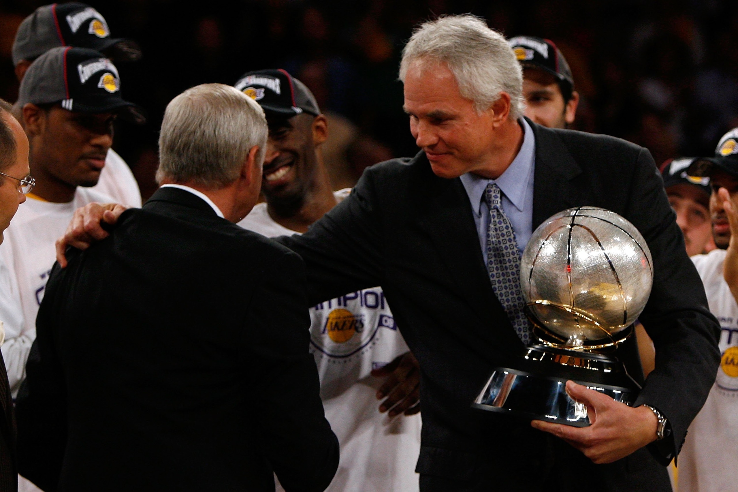LOS ANGELES, CA - MAY 29:  (L-R) NBA legend Jerry West shakes hands with Los Angeles Lakers general manager Mitch Kupchak after defeating the Lakers defeated the San Antonio Spurs 100-92 in Game Five of the Western Conference Finals during the 2008 NBA Pl