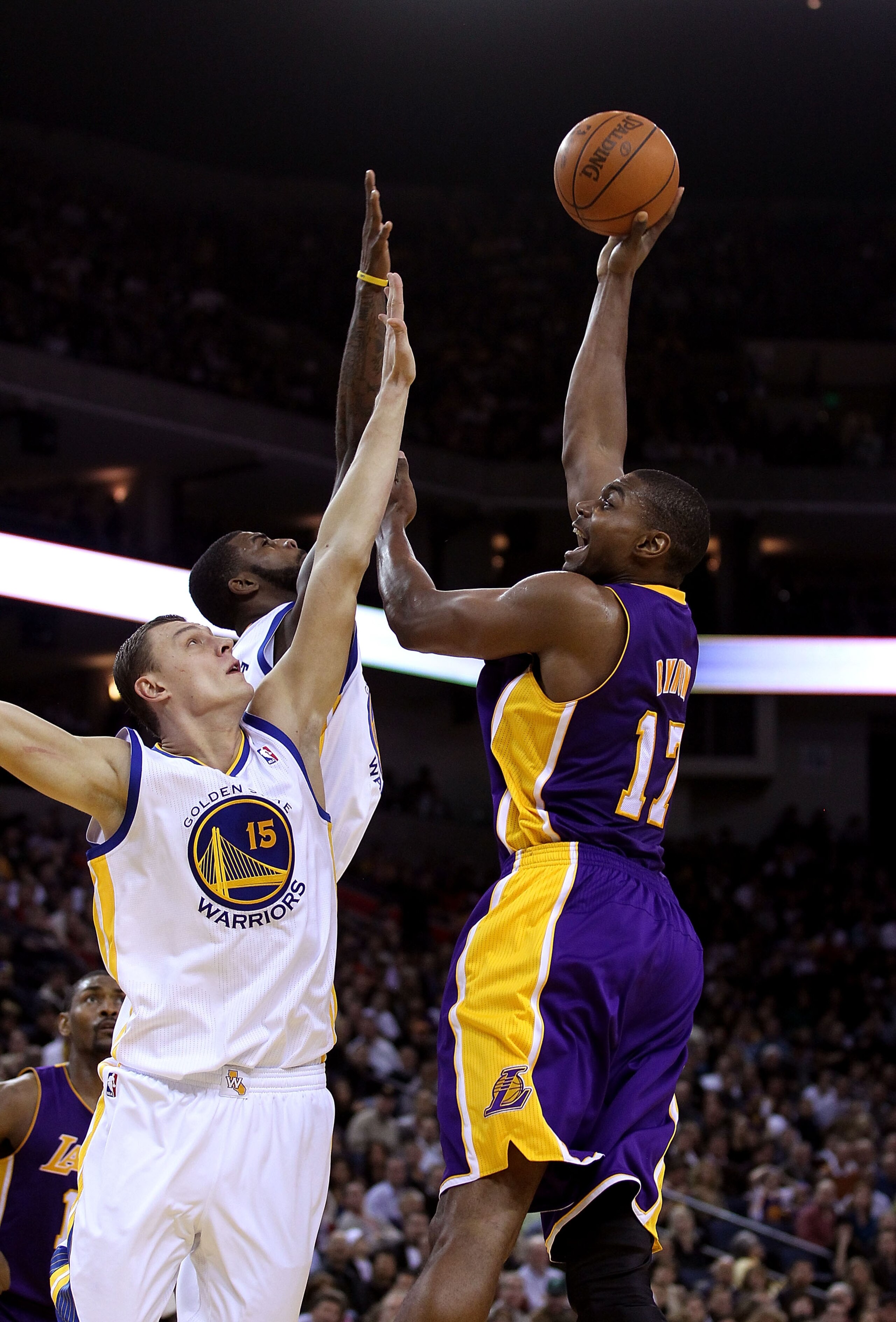 OAKLAND, CA - JANUARY 12: Andrew Bynum #17 of the Los Angeles Lakers shoots over Andris Biedrins #15 of the Golden State Warriors at Oracle Arena on January 12, 2011 in Oakland, California. NOTE TO USER: User expressly acknowledges and agrees that, by dow