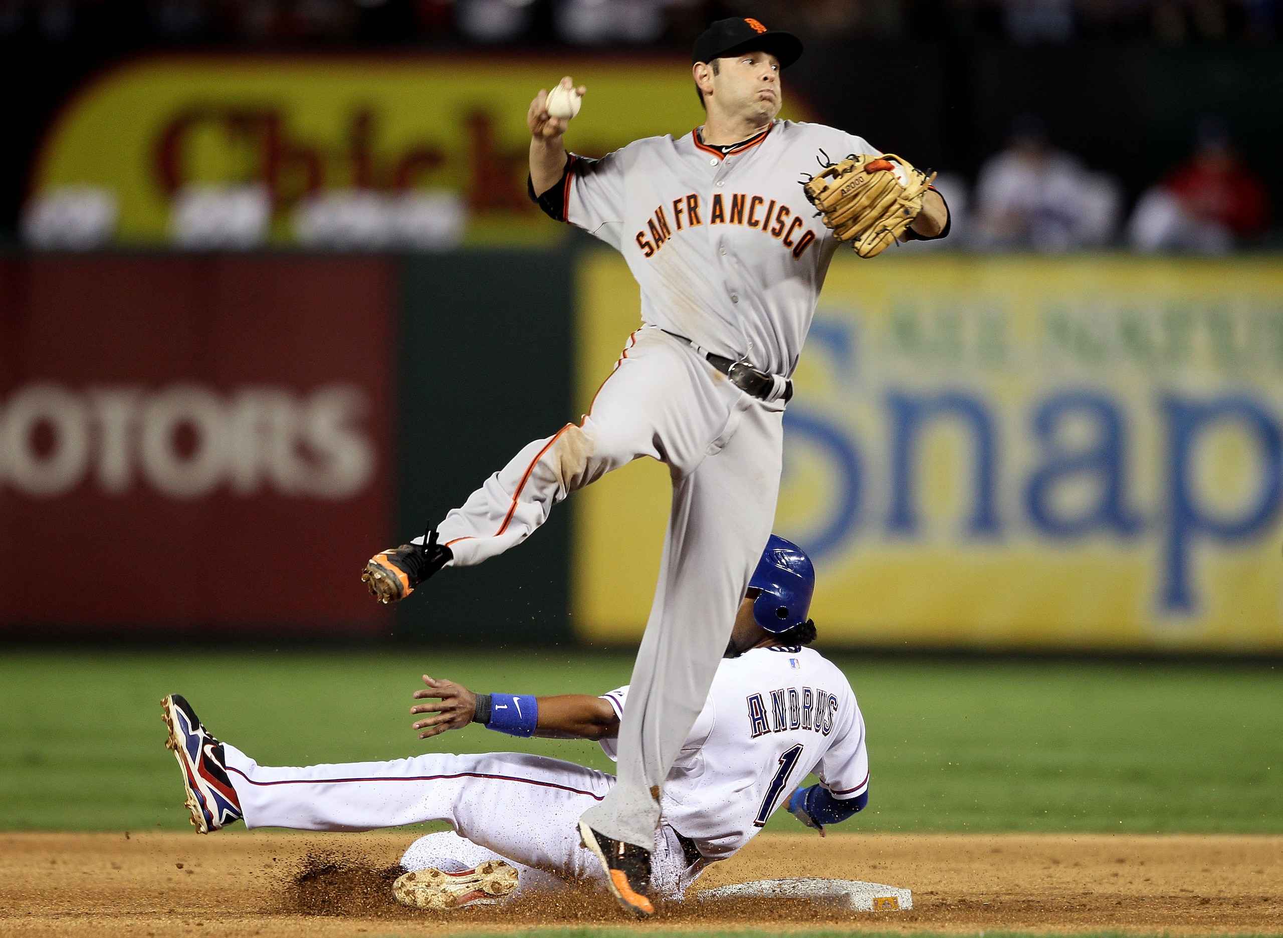 ARLINGTON, TX - OCTOBER 30:  Elvis Andrus #1 of the Texas Rangers tries to break up a double play in front of Freddy Sanchez #22 of the San Francisco Giants in Game Three of the 2010 MLB World Series at Rangers Ballpark in Arlington on October 30, 2010 in