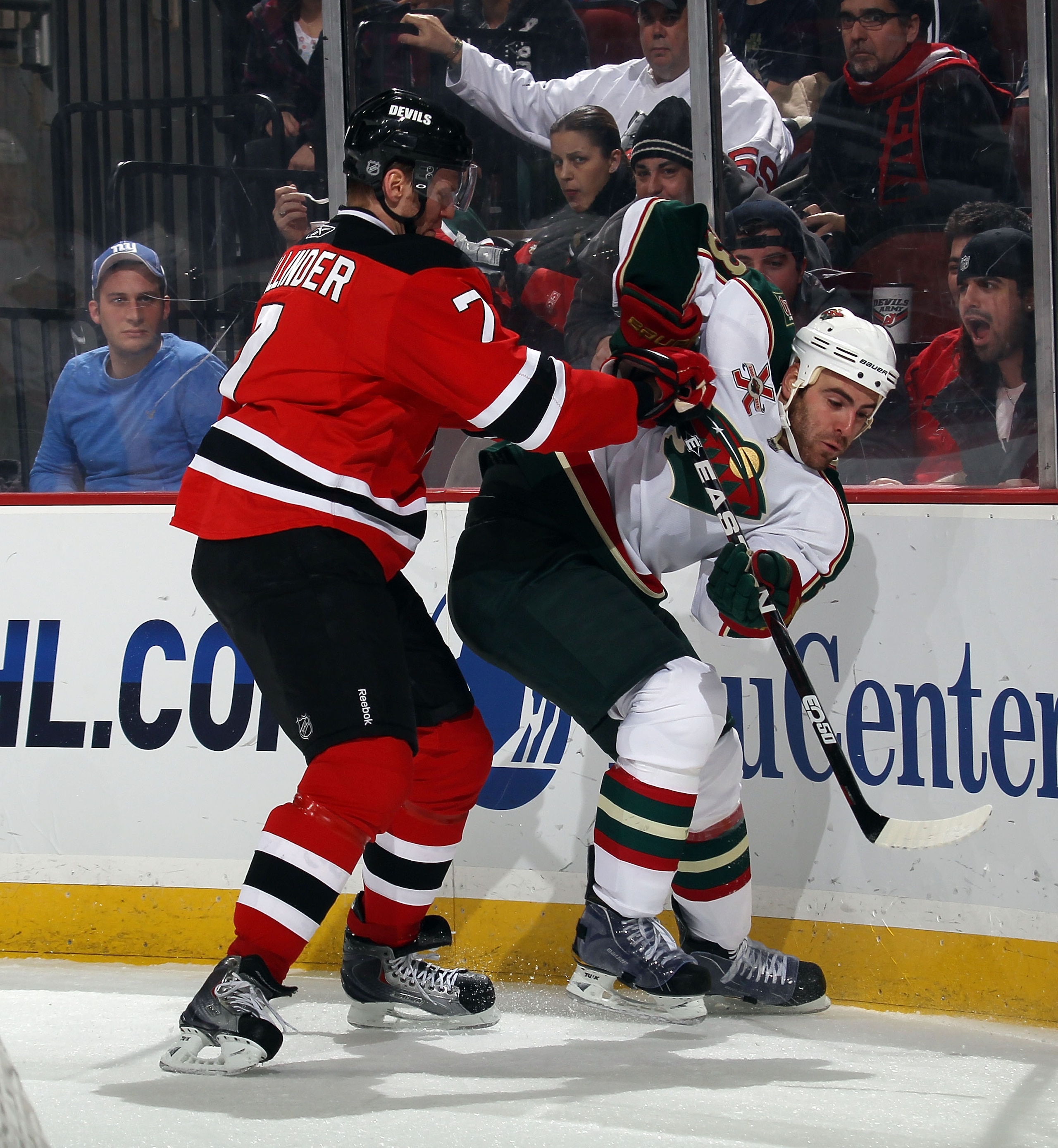 NEWARK, NJ - JANUARY 04: Eric Nystrom #23 of the Minnesota Wild is hit by Henrik Tallinder #7 of the New Jersey Devils  at the Prudential Center on January 4, 2011 in Newark, New Jersey.  (Photo by Bruce Bennett/Getty Images)