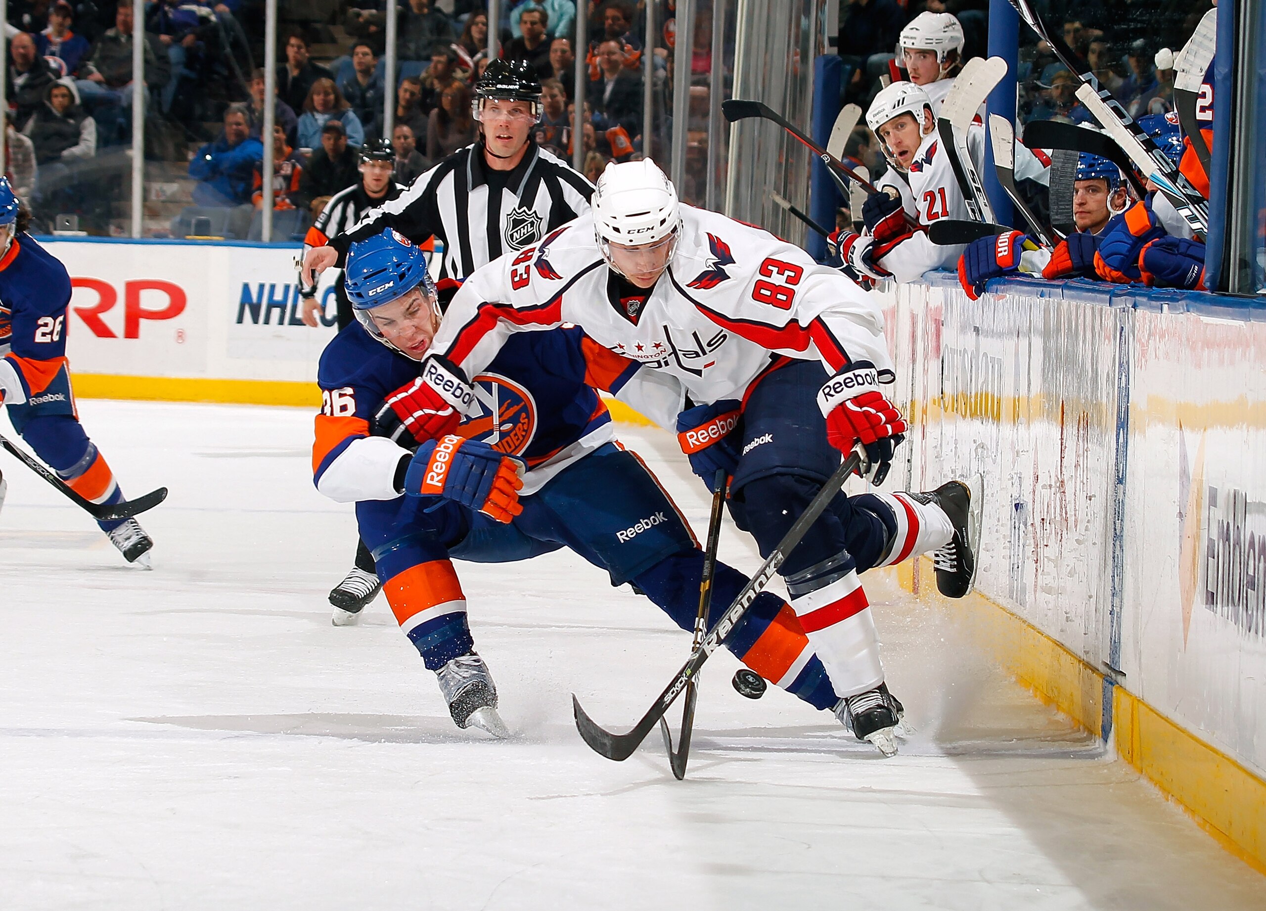 UNIONDALE, NY - JANUARY 20:  Jay Beagle #83 of the Washington Capitals skates for the puck against Travis Hamonic #36 of the New York Islanders on January 20, 2011 at Nassau Coliseum in Uniondale, New York.  (Photo by Lou Capozzola/Getty Images)
