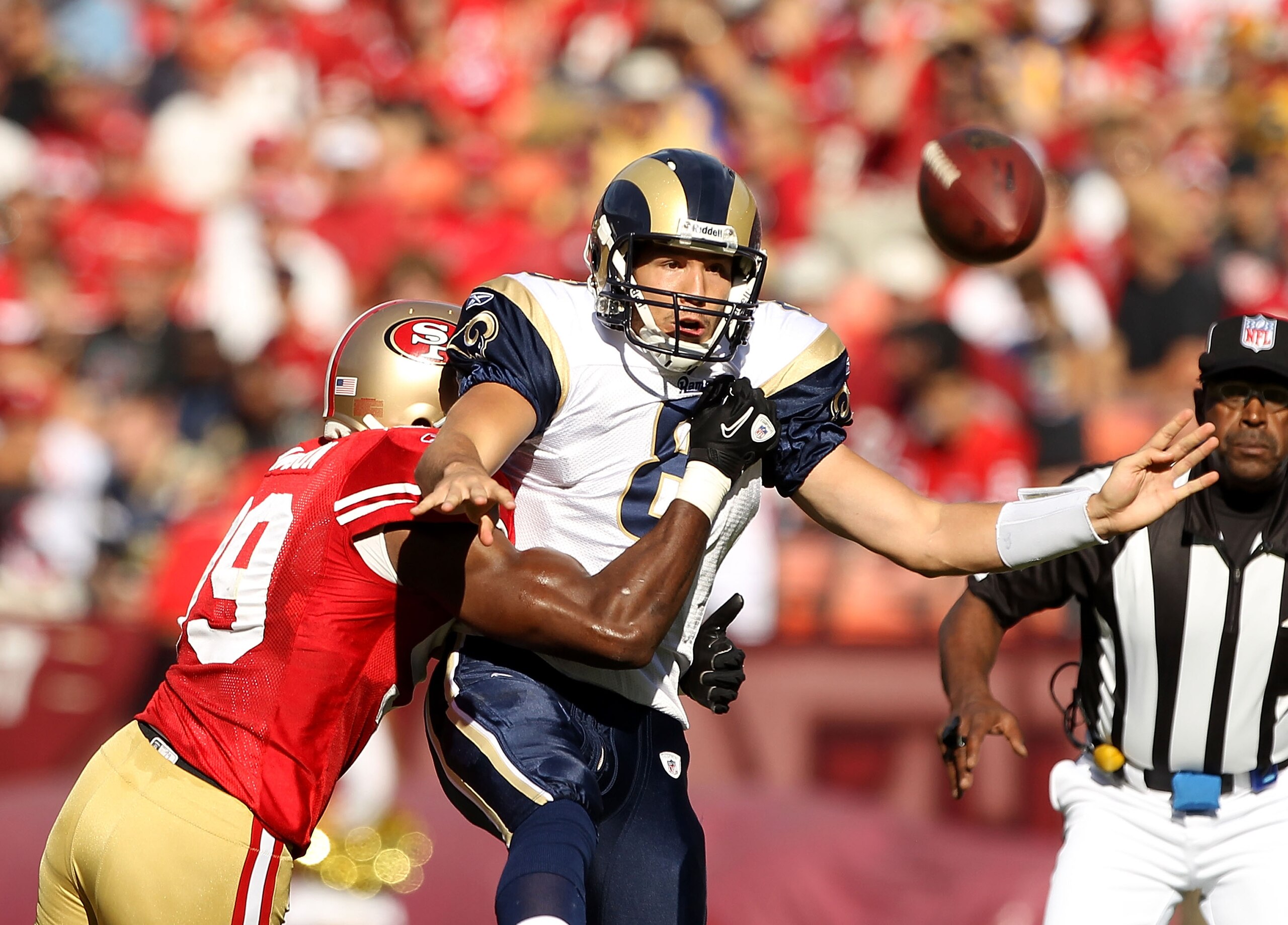 SAN FRANCISCO - NOVEMBER 14:  Sam Bradford #8  of the St. Louis Rams is hit by Manny Lawson #99 of the San Francisco 49ers at Candlestick Park on November 14, 2010 in San Francisco, California.  (Photo by Ezra Shaw/Getty Images)