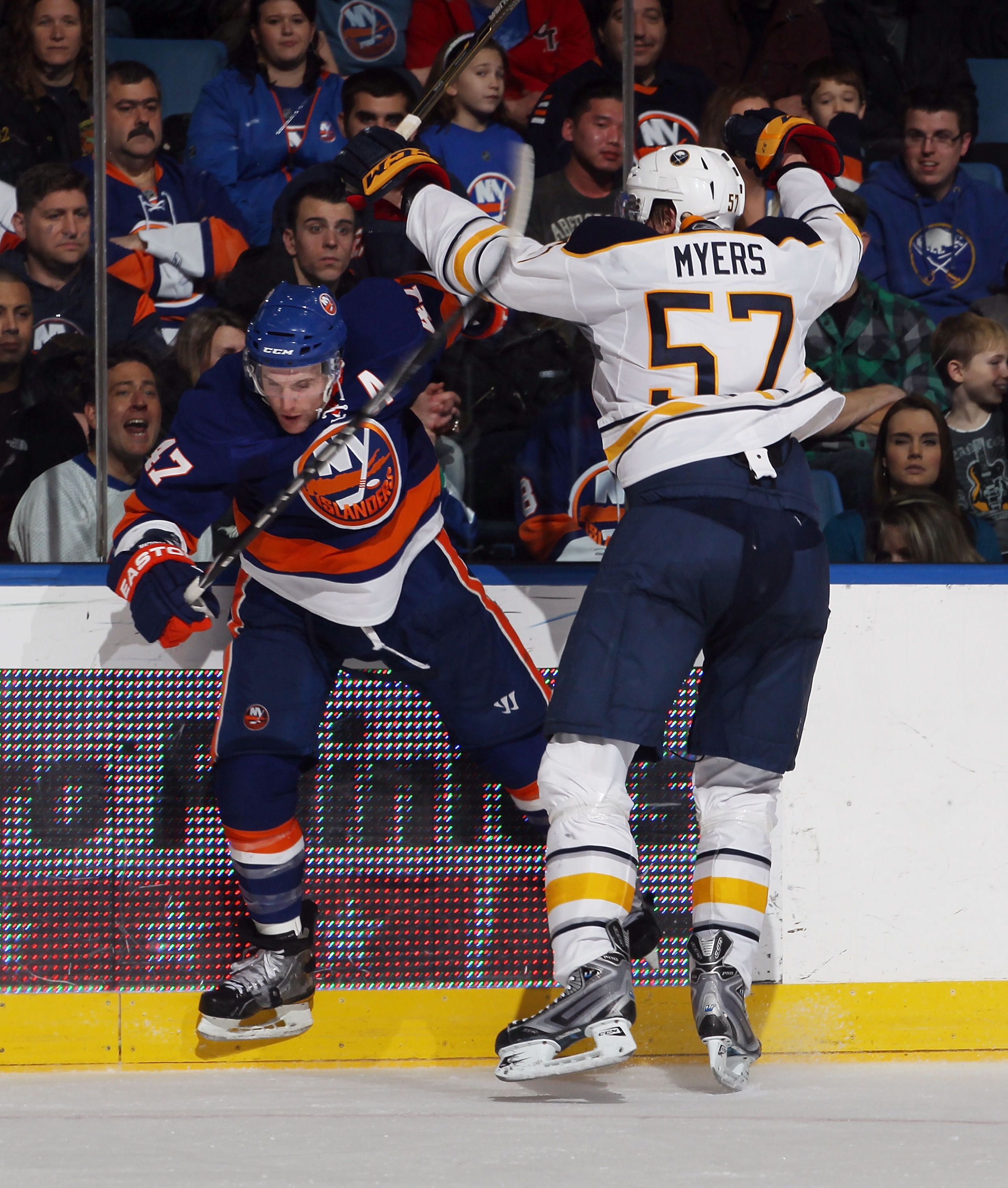 UNIONDALE, NY - JANUARY 15: Tyler Myers #57 of the Buffalo Sabres hits Andrew MacDonald #47 of the New York Islanders at the Nassau Coliseum on January 15, 2011 in Uniondale, New York. The Islanders defeated the Sabres 5-3. (Photo by Bruce Bennett/Getty I