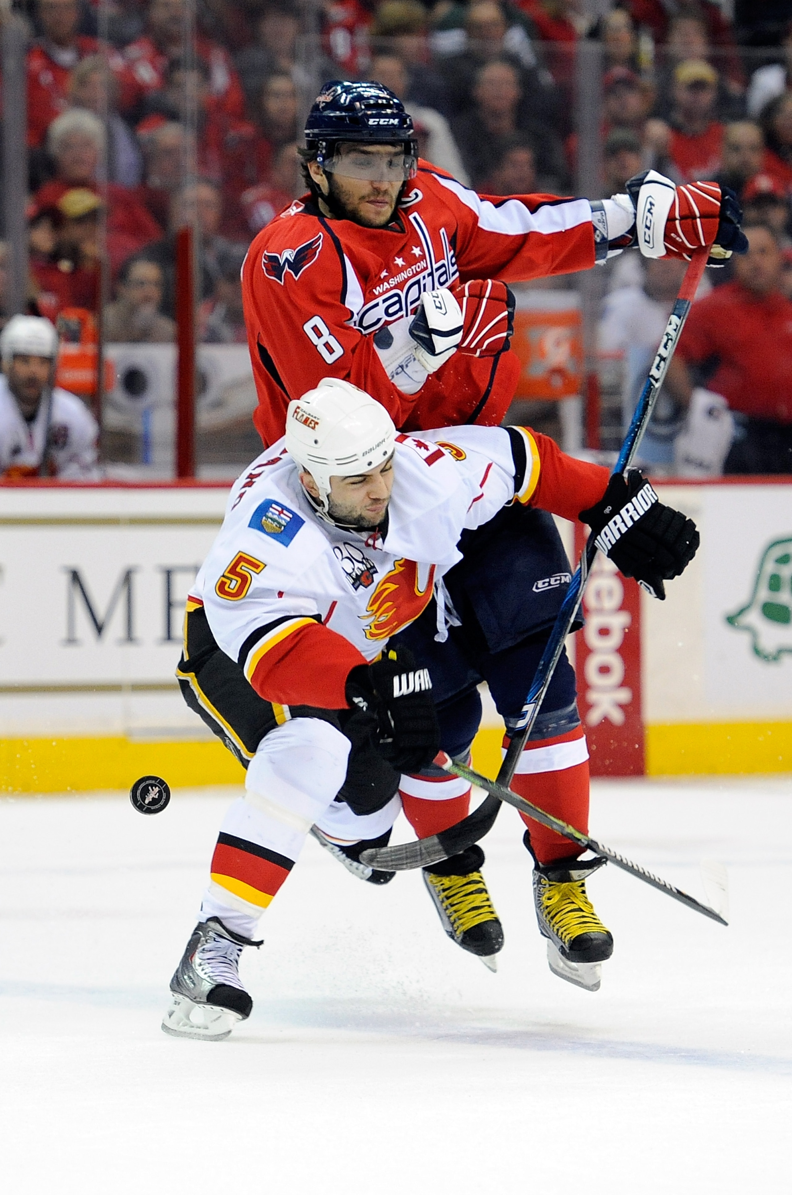 WASHINGTON - MARCH 28:  Alex Ovechkin #8 of the Washington Capitals collides with Mark Giordano #5 of the Calgary Flames on March 28, 2010 in Washington, DC.  (Photo by Greg Fiume/Getty Images)