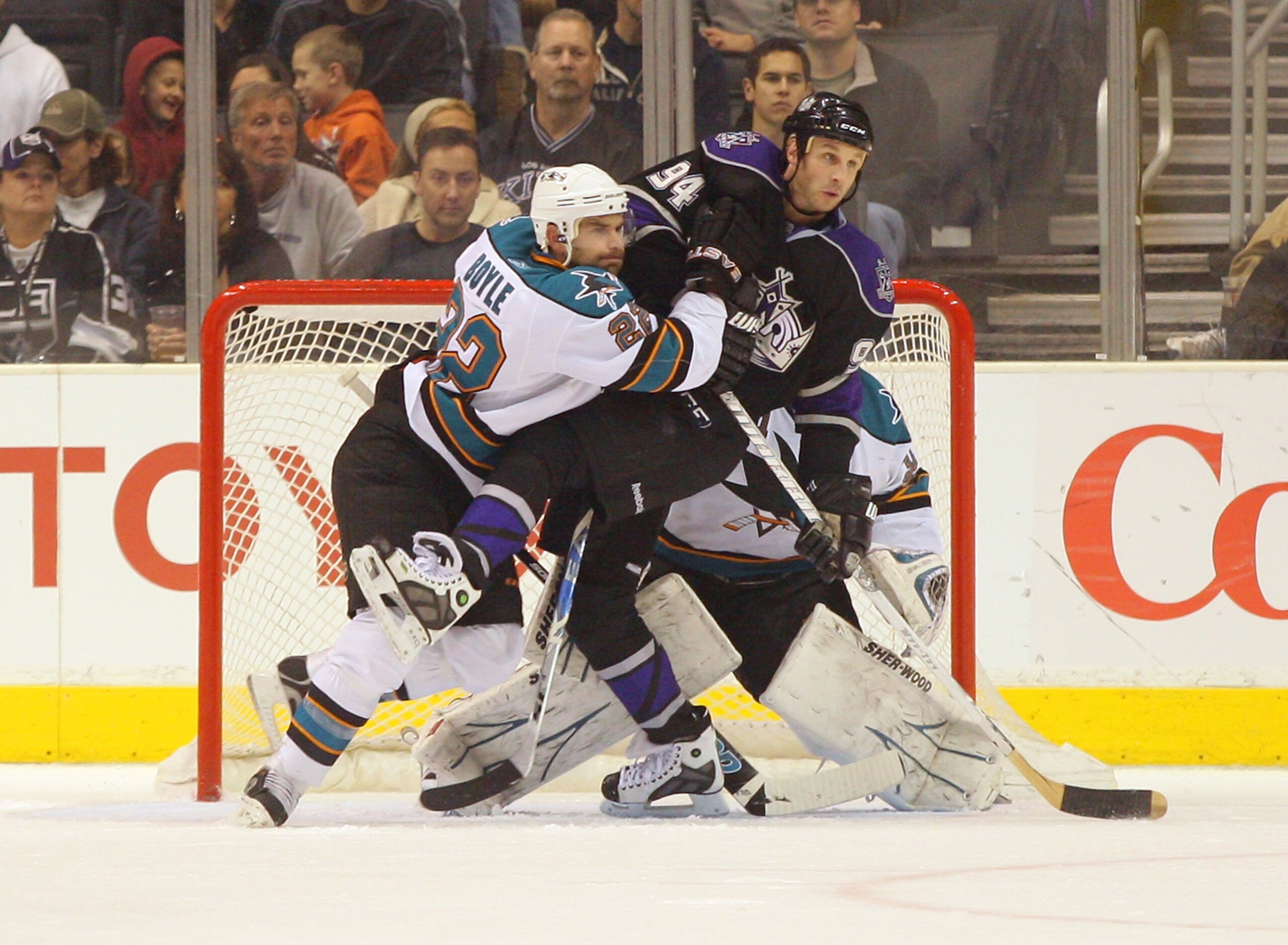 LOS ANGELES, CA - JANUARY 26:  Dan Boyle #22of the San Jose Sharks defends Ryan Smyth #94 of the Los Angeles Kings in the Sharks crease area during their NHL game at Staples Center on January 26, 2011 in Los Angeles, California. The Kings defeated the Sha