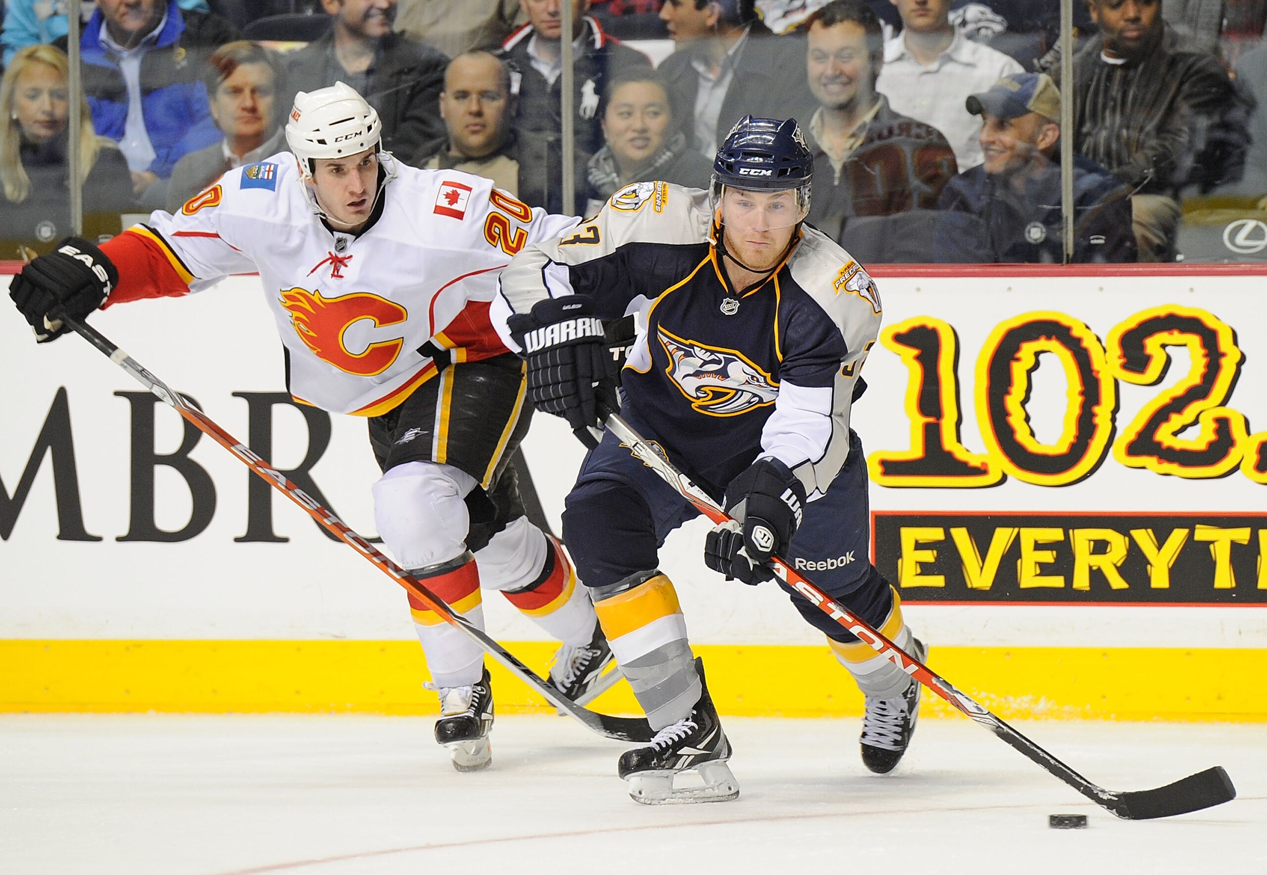 NASHVILLE, TN - FEBRUARY 01: Colin Wilson #33 of the Nashville Predators skats against Curtis Glencross #20 of the Calgary Flames on February 1, 2011 at the Bridgestone Arena in Nashville, Tennessee.  (Photo by Frederick Breedon/Getty Images)