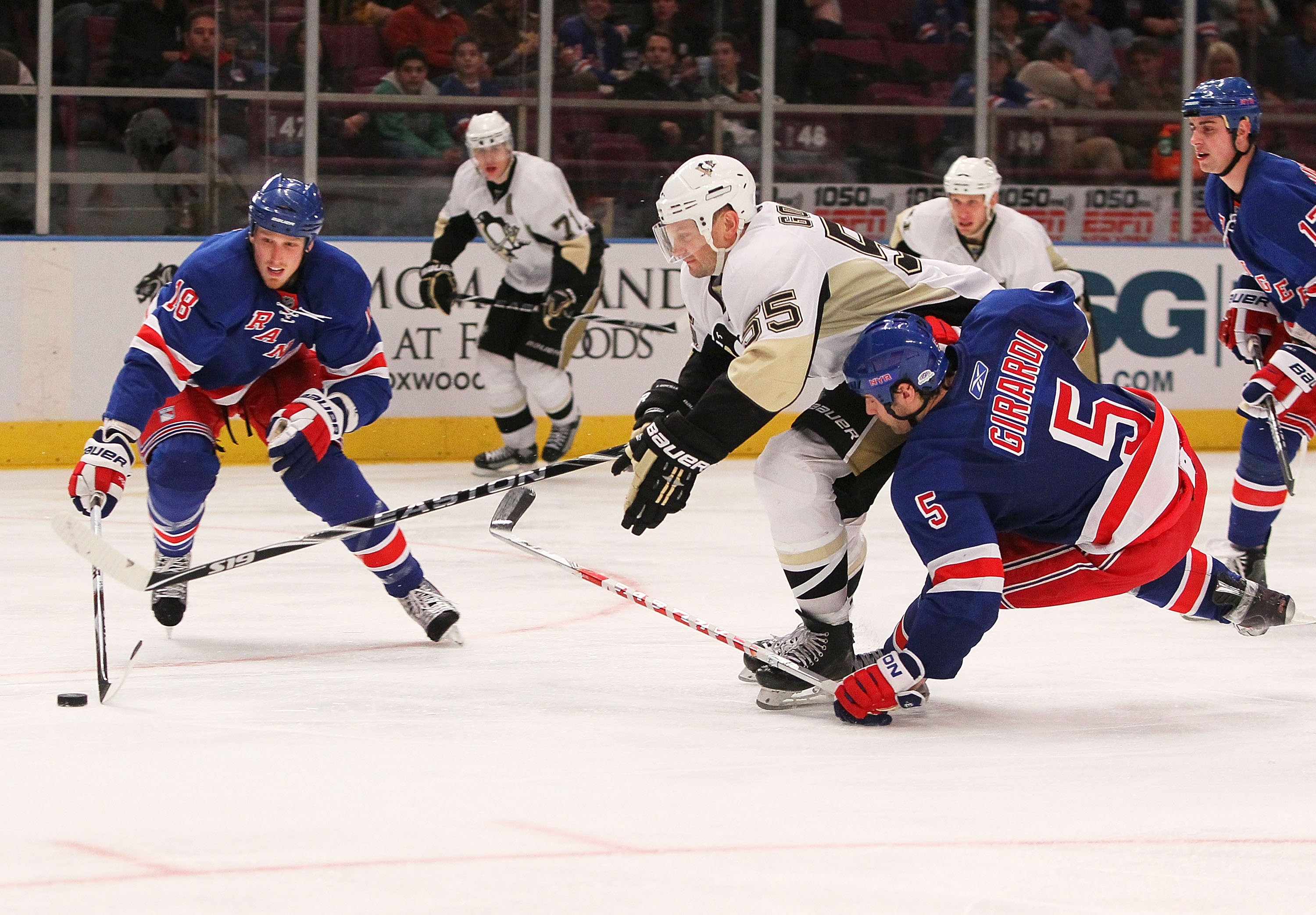 NEW YORK - JANUARY 25:  Sergei Gonchar #55 of the Pittsburgh Penguins battles for the puck against Dan Girardi #5 and Marc Staal #18 of the New York Rangers on January 25, 2010 at Madison Square Garden in New York City. Penguins defeated the Rangers 4-2.