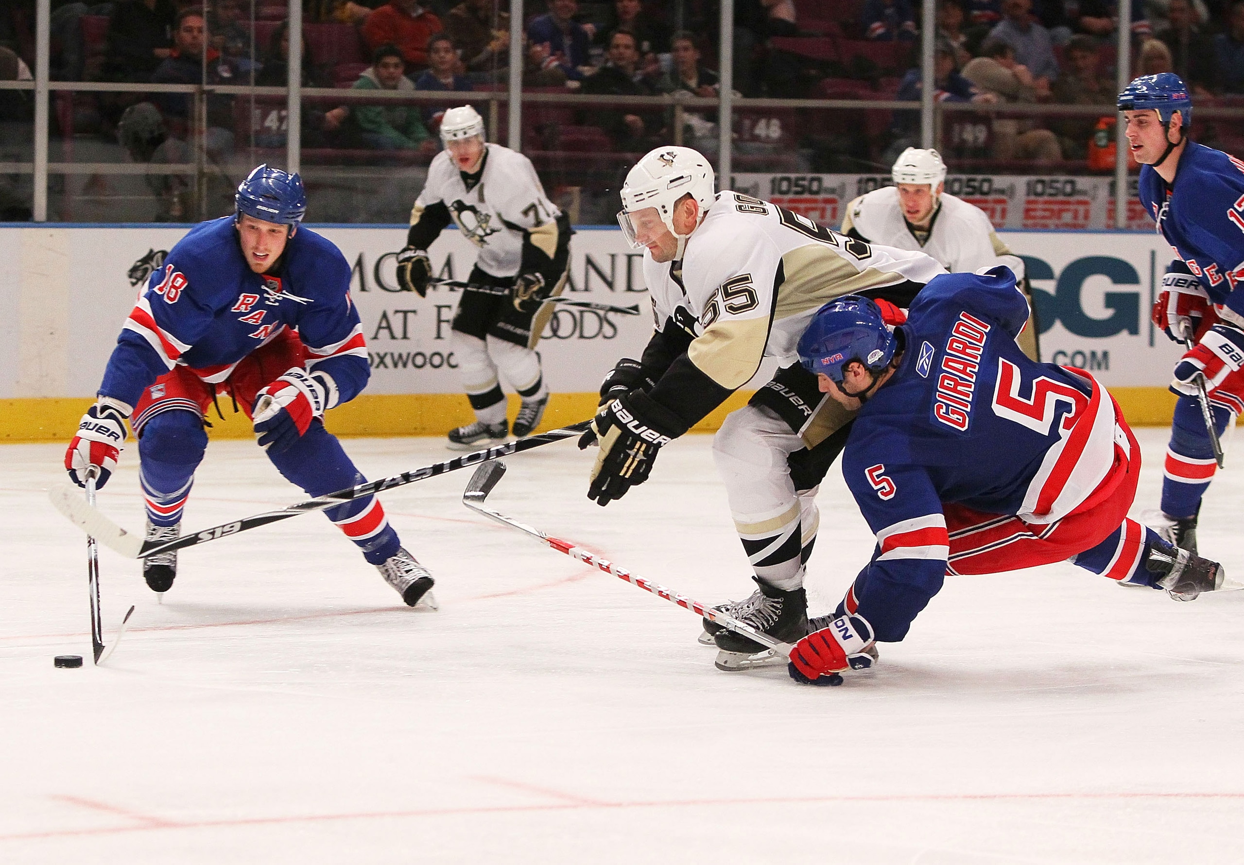 NEW YORK - JANUARY 25:  Sergei Gonchar #55 of the Pittsburgh Penguins battles for the puck against Dan Girardi #5 and Marc Staal #18 of the New York Rangers on January 25, 2010 at Madison Square Garden in New York City. Penguins defeated the Rangers 4-2.