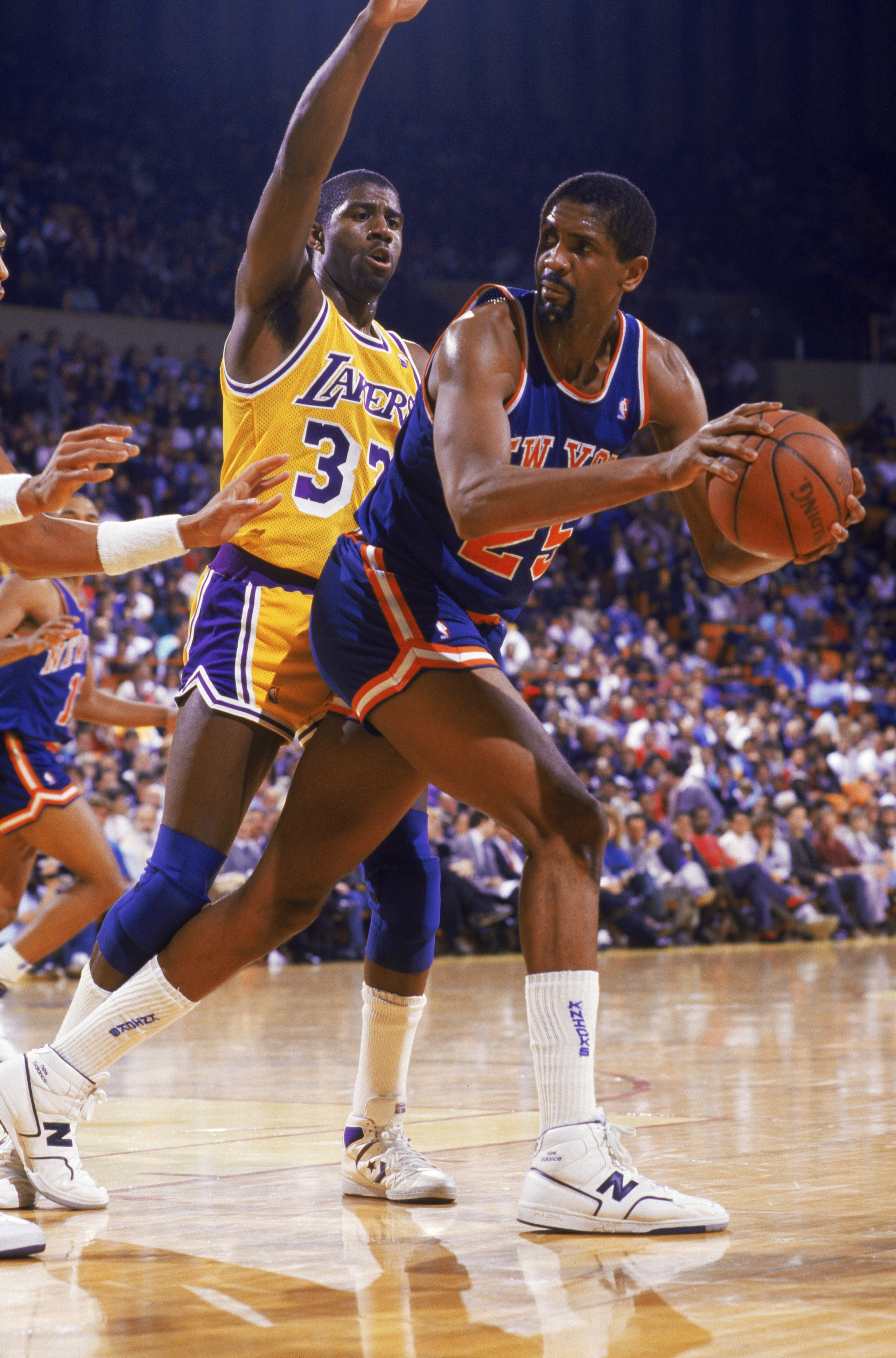 NEW YORK - 1987:  Bill Cartwright #25 of the New York Knicks posts up Magic Johnson #32 of the Los Angeles Lakers during an NBA game at Madison Square Garden in New York City, New York in 1987.  (Photo by: Stephen Dunn/Getty Images)
