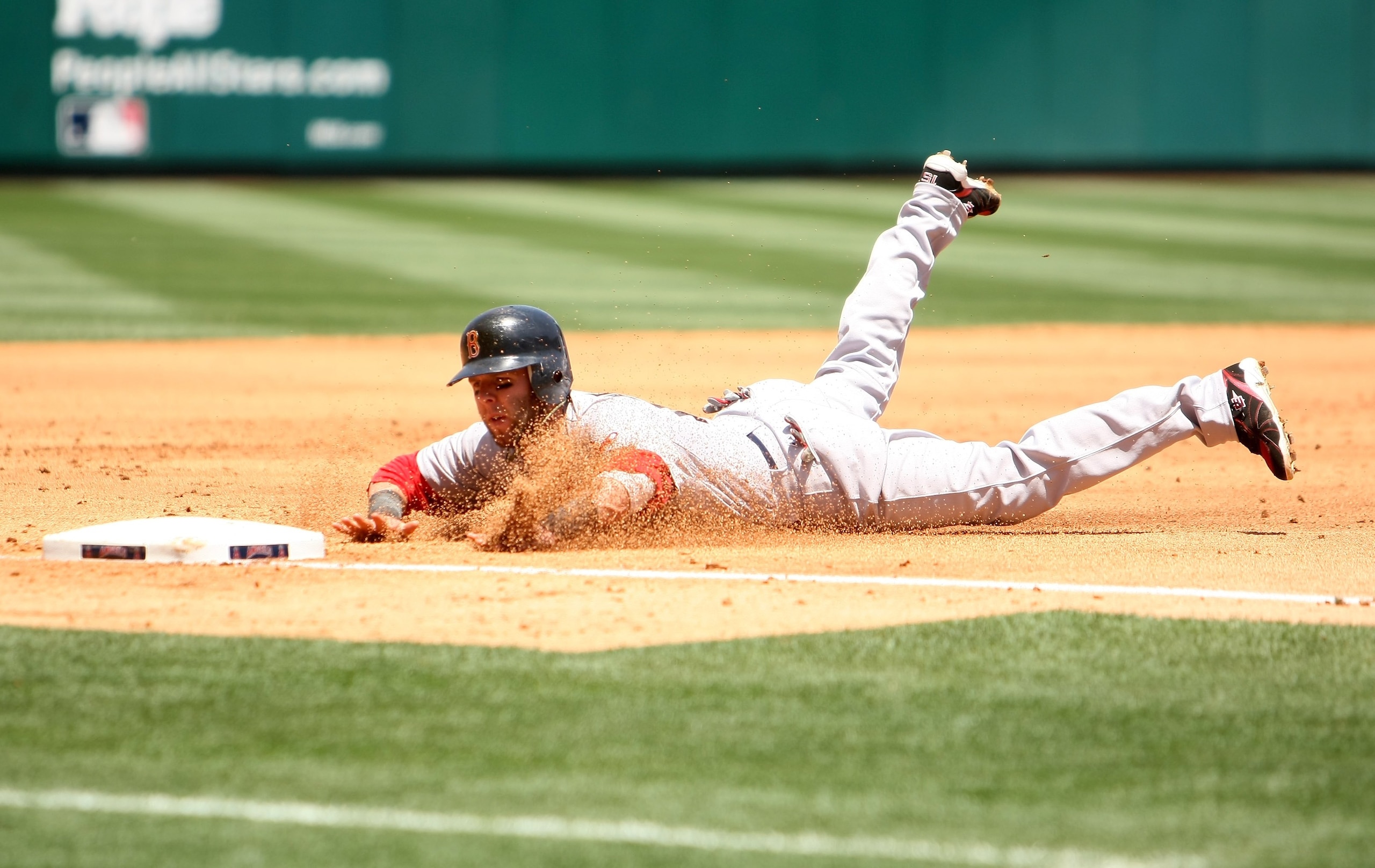 ANAHEIM, CA - MAY 14:  Dustin Pedroia #15 of the Boston Red Sox slides into third base against the Los Angeles Angels of Anaheim on May 14, 2009 at Angel Stadium in Anaheim, California.   The Angels won 5-4 in 12 innings.  (Photo by Stephen Dunn/Getty Ima