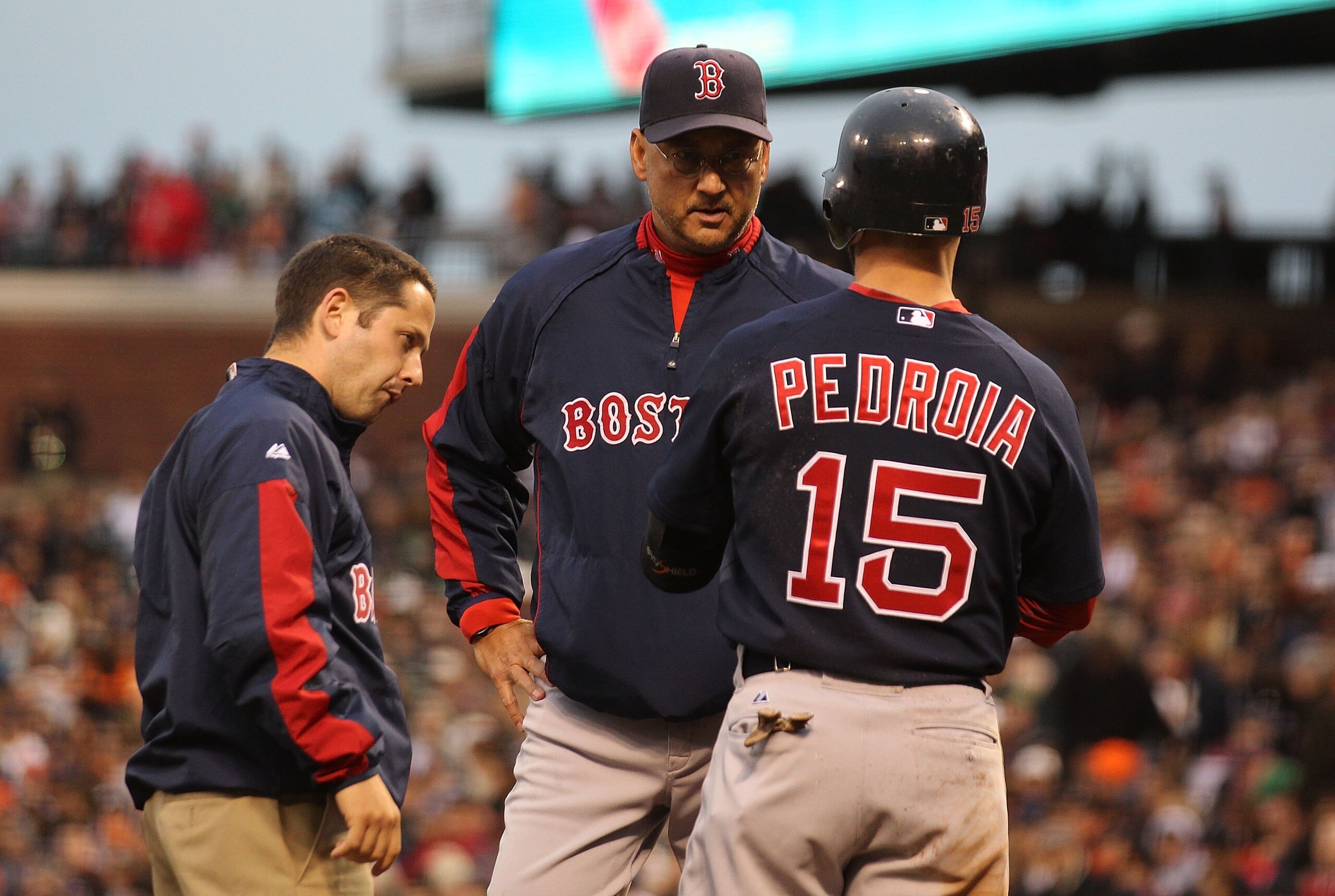 SAN FRANCISCO - JUNE 25:  Dustin Pedroia #15 of the Boston Red Sox looks on as manager Terry Francona and a trainer examine his leg after being struck by a foul ball against the San Francisco Giants in the third inning during an MLB game at AT&T Park on J