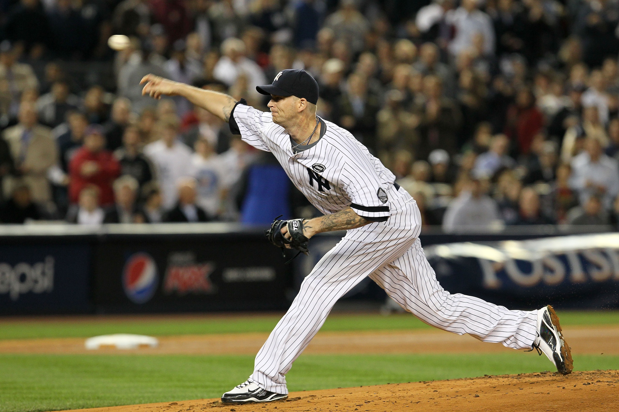 NEW YORK - OCTOBER 19:  A.J. Burnett #34 of the New York Yankees pitches against the Texas Rangers in Game Four of the ALCS during the 2010 MLB Playoffs at Yankee Stadium on October 19, 2010 in the Bronx borough of New York City. The Rangers won 10-3.  (P