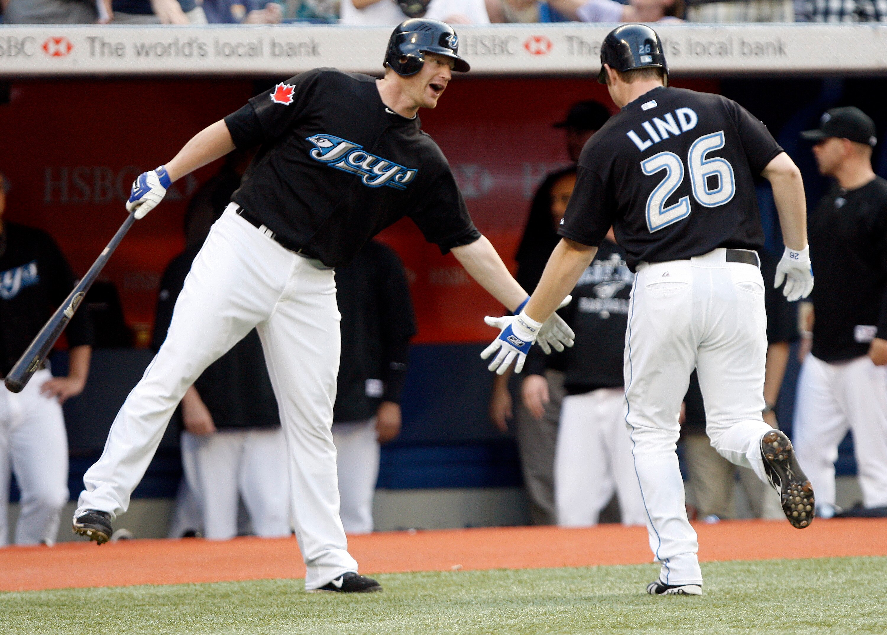 TORONTO - JULY 8: Lyle Overbay #35 and Adam Lind #26 of the Toronto Blue Jays celebrate Lind's home run against the Minnesota Twins during a MLB game at The Rogers Centre July 8, 2010 in Toronto, Ontario, Canada. (Photo by Abelimages/Getty Images)