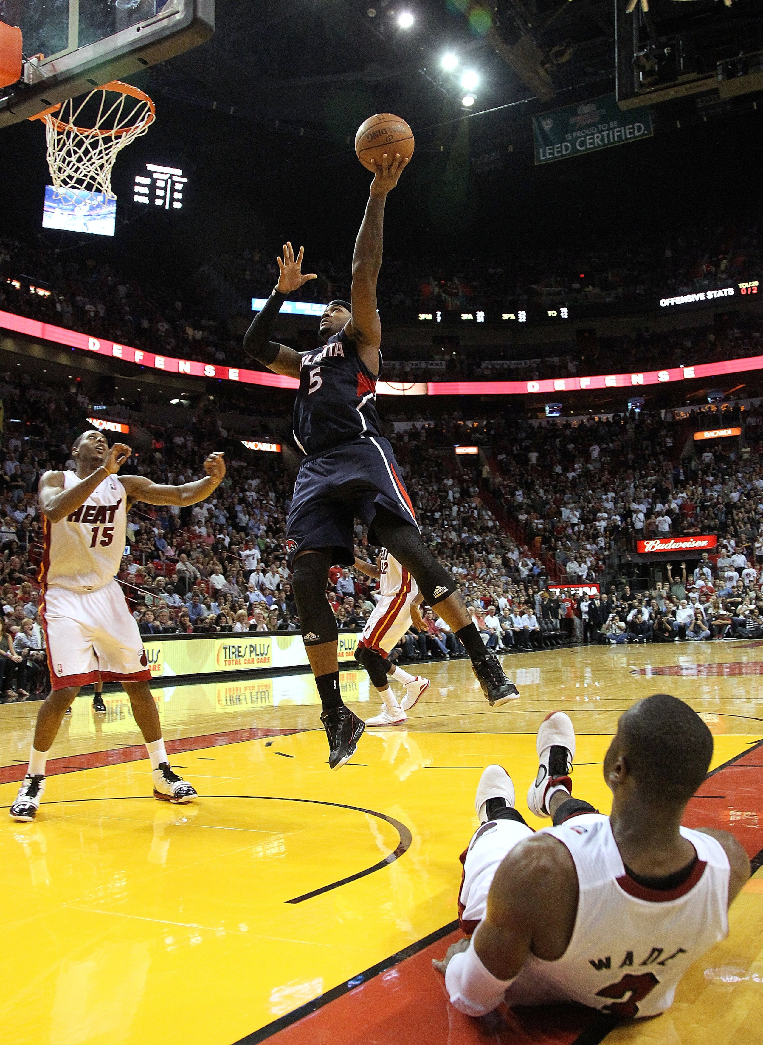 MIAMI, FL - JANUARY 18:  Josh Smith #5 of the Atlanta Hawks shoots over Dwyane Wade #3 of the Miami Heat  during a game at American Airlines Arena on January 18, 2011 in Miami, Florida. NOTE TO USER: User expressly acknowledges and agrees that, by downloa