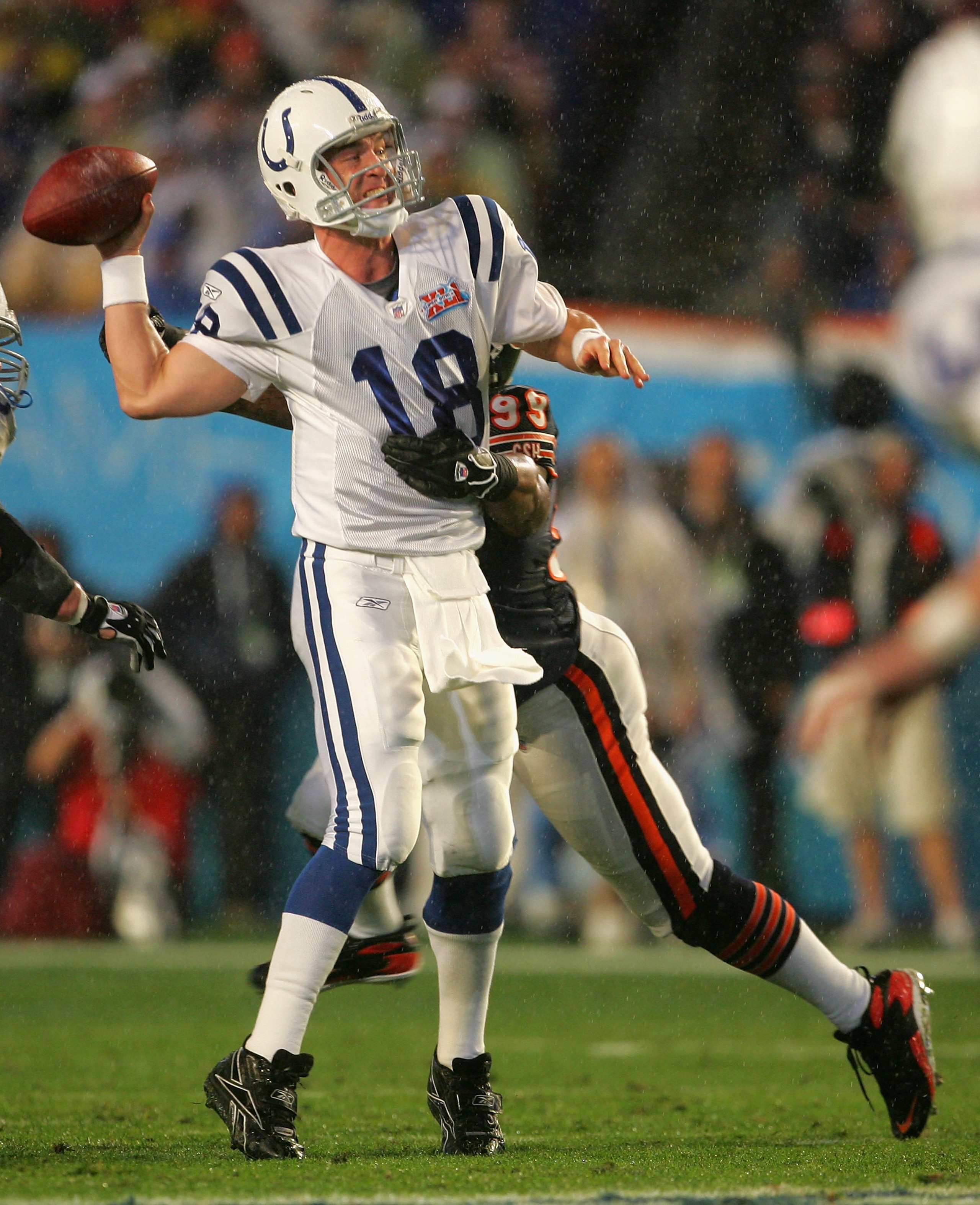 MIAMI GARDENS, FL - FEBRUARY 04: Quarterback Peyton Manning #18 of the Indianapolis Colts scrambles to throw a touchdown under pressure from defensive tackle Tank Johnson #99 of the Chicago Bears in the first quarter of Super Bowl XLI on February 4, 2007 MIAMI GARDENS, FL - FEBRUARY 04: Quarterback Peyton Manning #18 of the Indianapolis Colts scrambles to throw a touchdown under pressure from defensive tackle Tank Johnson #99 of the Chicago Bears in the first quarter of Super Bowl XLI on February 4, 2007