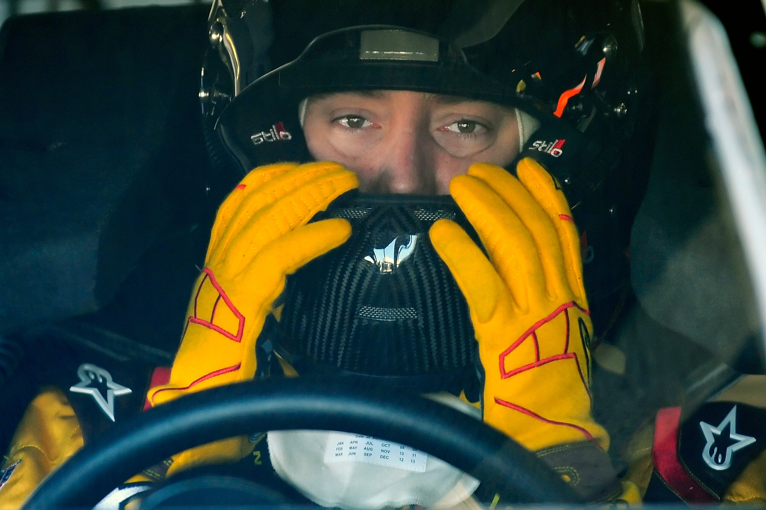 DAYTONA BEACH, FL - JANUARY 22:  Kyle Busch, driver of the #18 M&M's Toyota, adjusts his helmet prior to testing at Daytona International Speedway on January 22, 2011 in Daytona Beach, Florida.  (Photo by Jared C. Tilton/Getty Images for NASCAR)