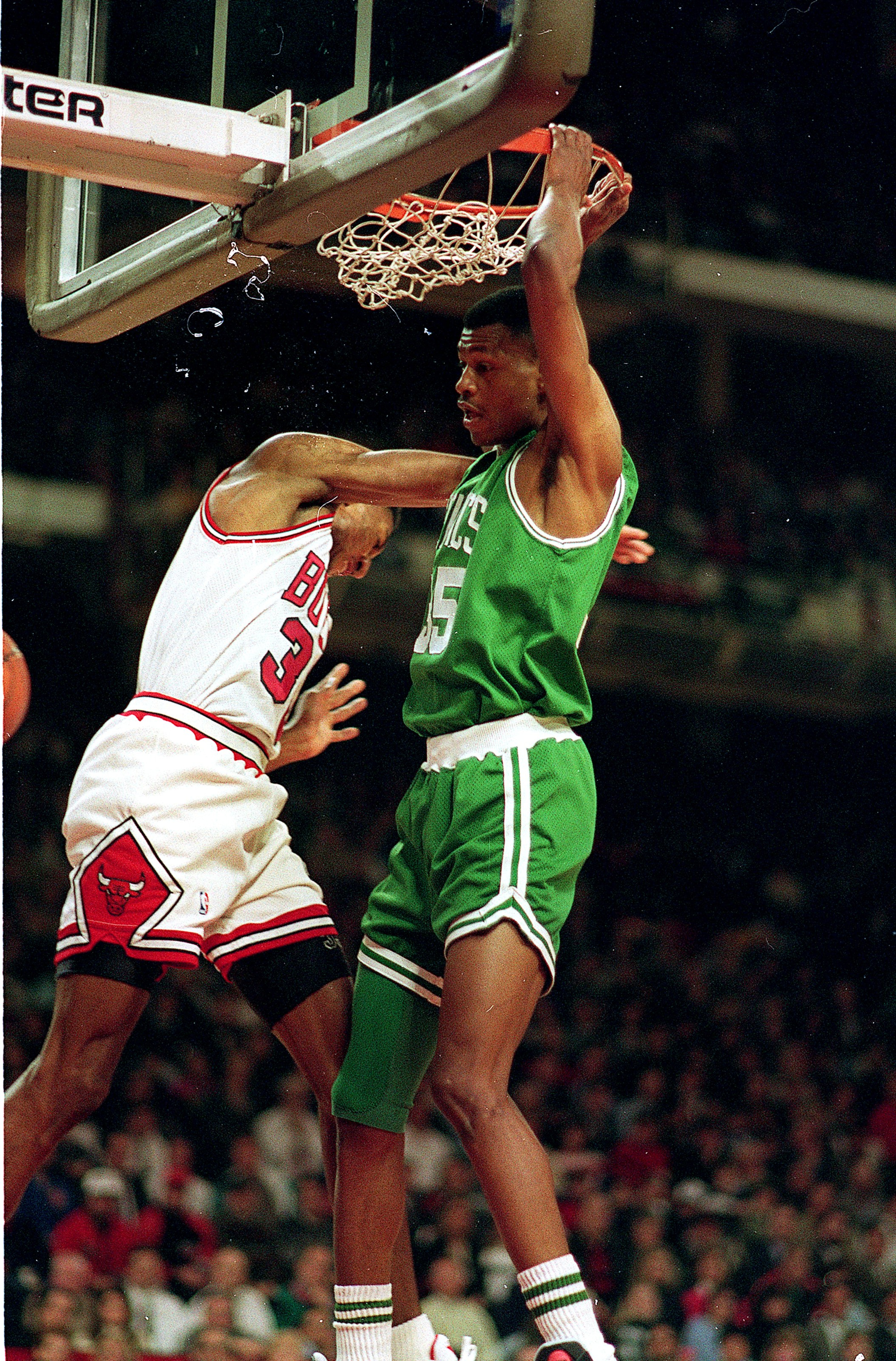 CHICAGO - DECEMBER 18: Reggie Lewis of the Boston Celtics makes a slam dunk during the NBA game against the Chicago Bulls in the United Center on December 18, 1993 in Chicago, Illinois. NOTE TO USER: User expressly acknowledges and agrees that, by downlo CHICAGO - DECEMBER 18: Reggie Lewis of the Boston Celtics makes a slam dunk during the NBA game against the Chicago Bulls in the United Center on December 18, 1993 in Chicago, Illinois. NOTE TO USER: User expressly acknowledges and agrees that, by downlo