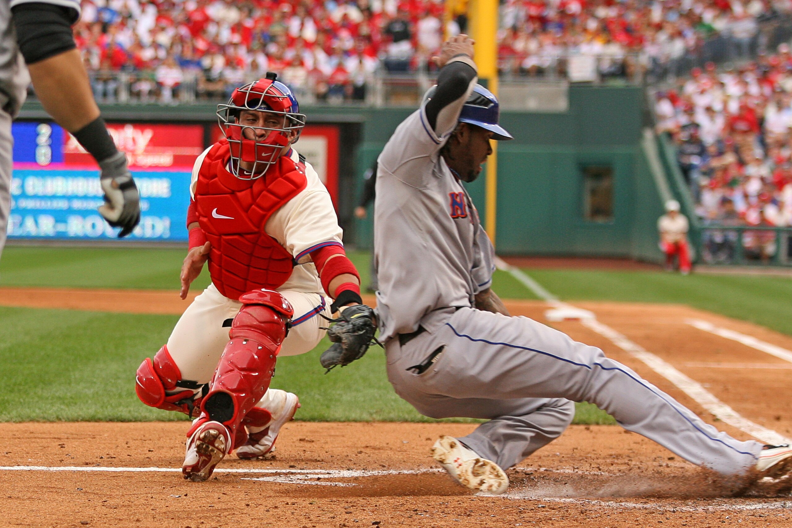 PHILADELPHIA - SEPTEMBER 26: Catcher Carlos Ruiz #51 of the Philadelphia Phillies tags out shortstop Jose Reyes #7 of the New York Mets at home plate during a game at Citizens Bank Park on September 26, 2010 in Philadelphia, Pennsylvania. (Photo by Hunter