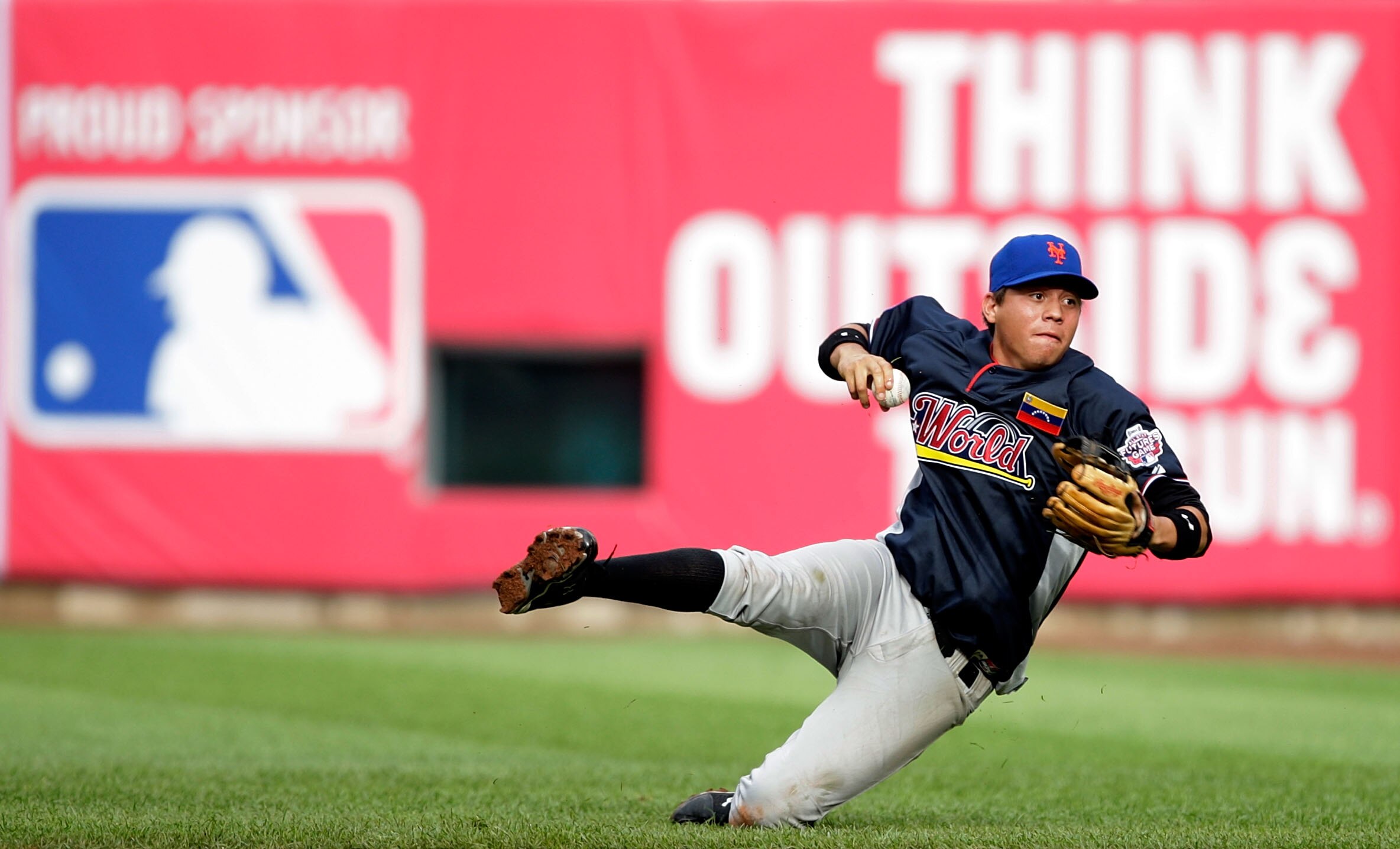 ST LOUIS, MO - JULY 12:  World Futures All-Star Wilmer Flores of the New York Mets tries to throw to first base against the U.S. Futures All-Stars during the 2009 XM All-Star Futures Game at Busch Stadium on July 12, 2009 the in St. Louis, Missouri.  (Pho
