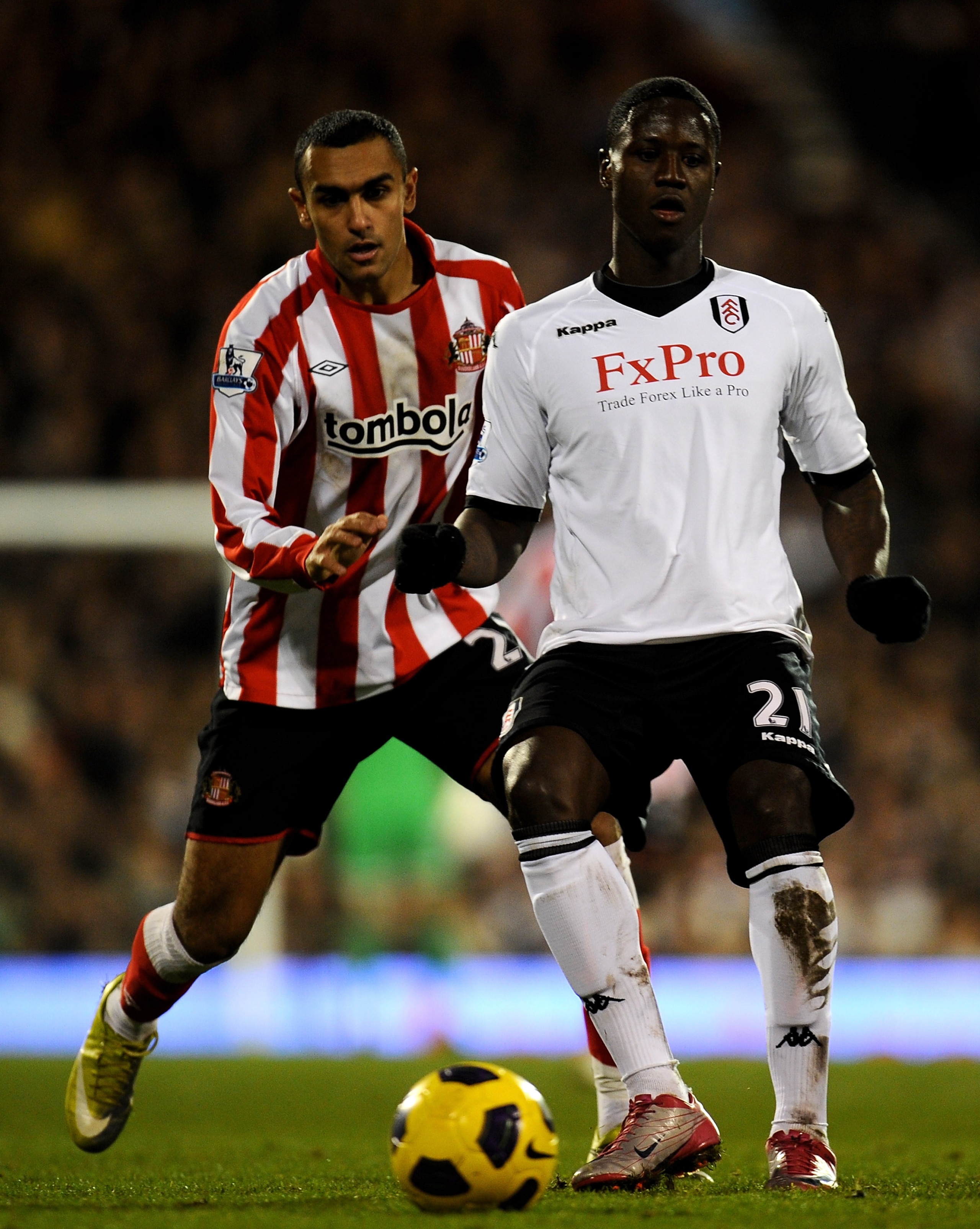 LONDON, ENGLAND - DECEMBER 11:  Eddie Johnson (R) of Fulham in action against Ahmed Elmomahady of Sunderland during the Barclays Premier League match between Fulham and Sunderland at Craven Cottage on December 11, 2010 in London, England.  (Photo by Clive