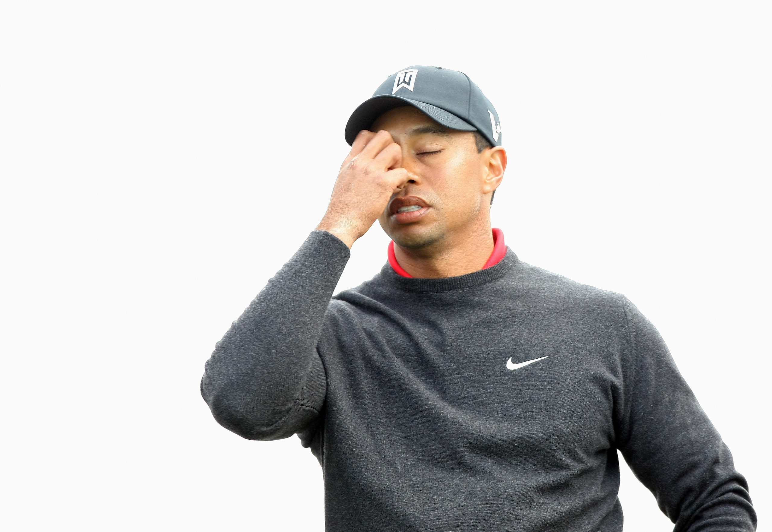 LA JOLLA, CA - JANUARY 30:  Tiger Woods wipes his face on the 3rd tee during the final round of the Farmers Insurance Open at the Torrey Pines South Course on January 30, 2011 in La Jolla, California.  (Photo by Donald Miralle/Getty Images)