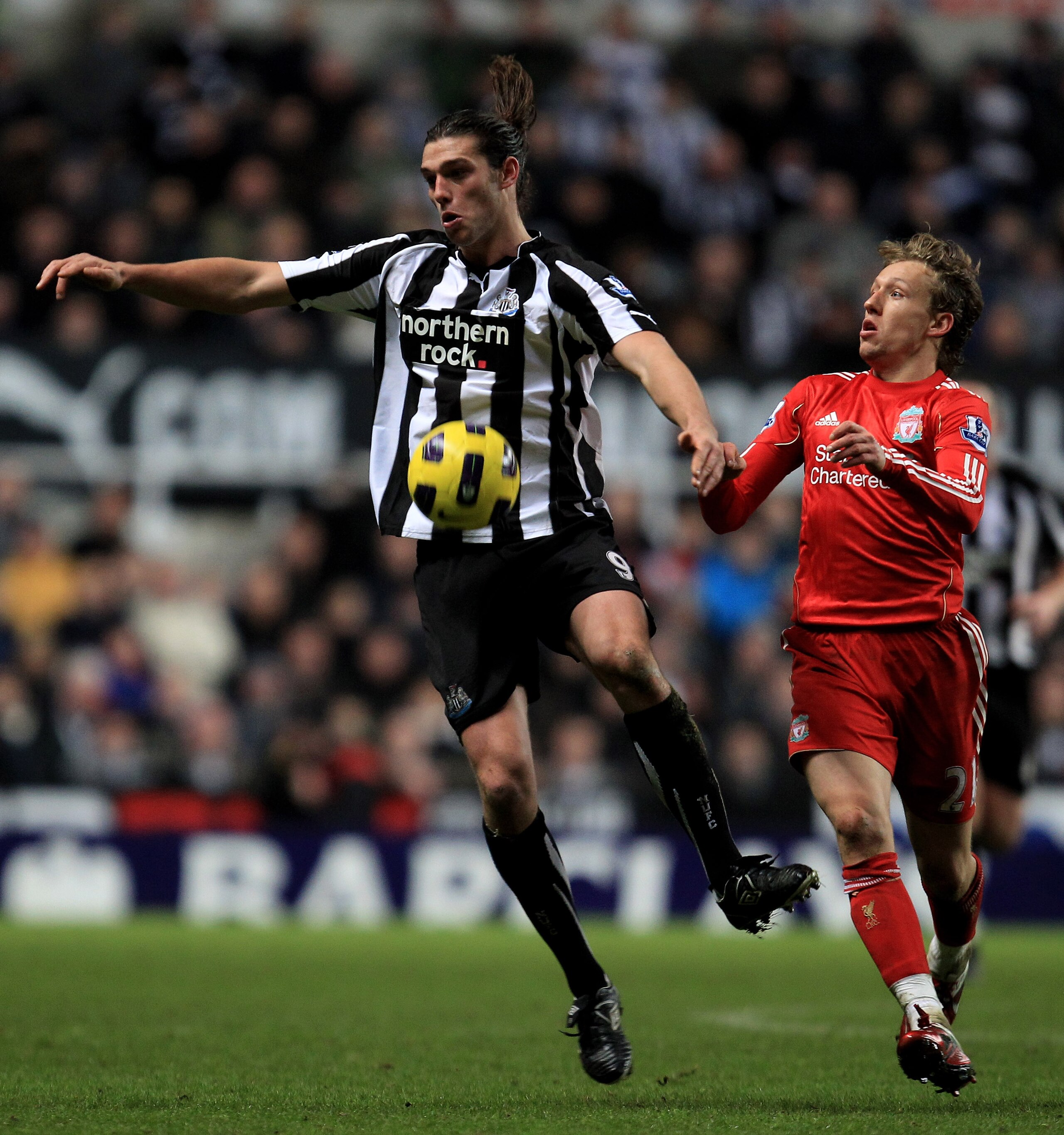 NEWCASTLE UPON TYNE, ENGLAND - DECEMBER 11:  Andy Carroll of Newcastle United competes with Lucas of Liverpool during the Barclays Premier League match between Newcastle United and Liverpool at St James' Park on December 11, 2010 in Newcastle, England.  (