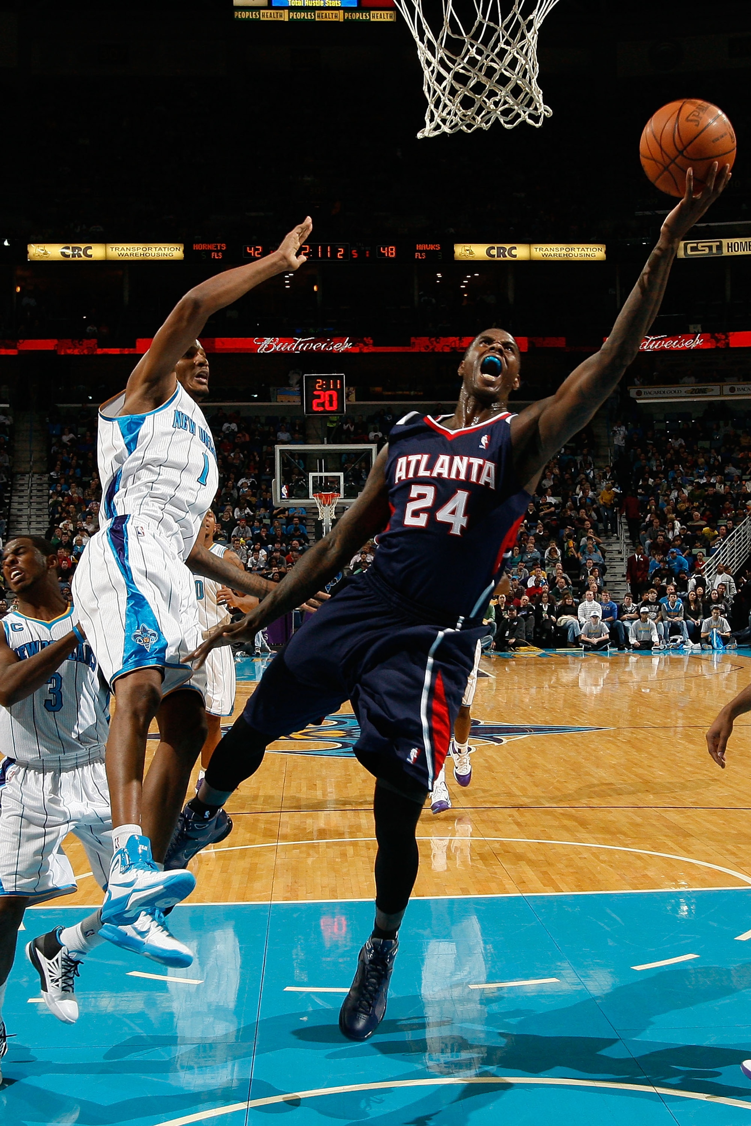 NEW ORLEANS, LA - DECEMBER 26:  Marvin Williams #24 of the Atlanta Hawks shoots the ball over Trevor Ariza #1 of the New Orleans Hornets at the New Orleans Arena on December 26, 2010 in New Orleans, Louisiana.  NOTE TO USER: User expressly acknowledges an