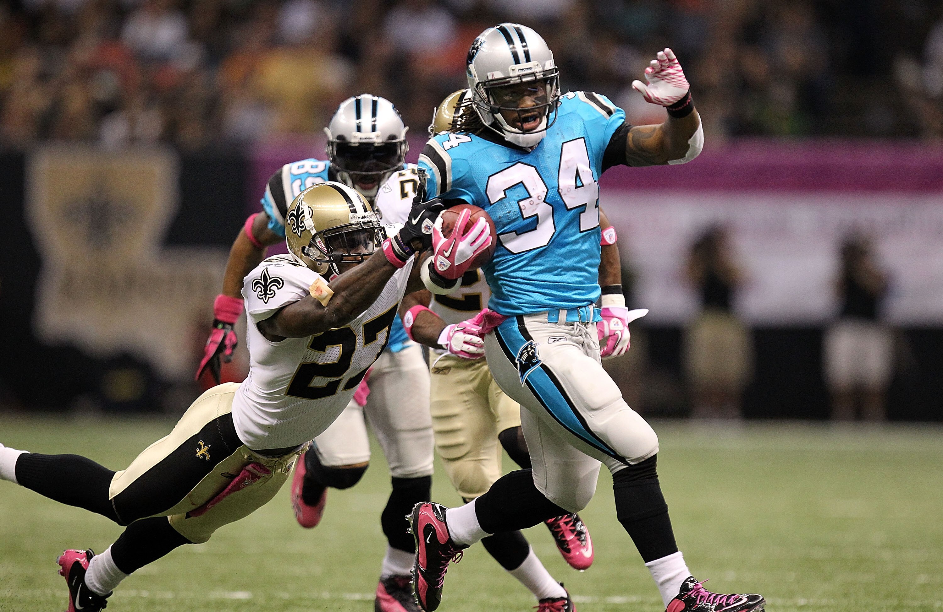 NEW ORLEANS - OCTOBER 03:  Running back DeAngelo Williams #34 of the Carolina Panthers runs for a touchdown past Malcolm Jenkins #27 of the New Orleans Saints at the Louisiana Superdome on October 3, 2010 in New Orleans, Louisiana.  (Photo by Ronald Marti