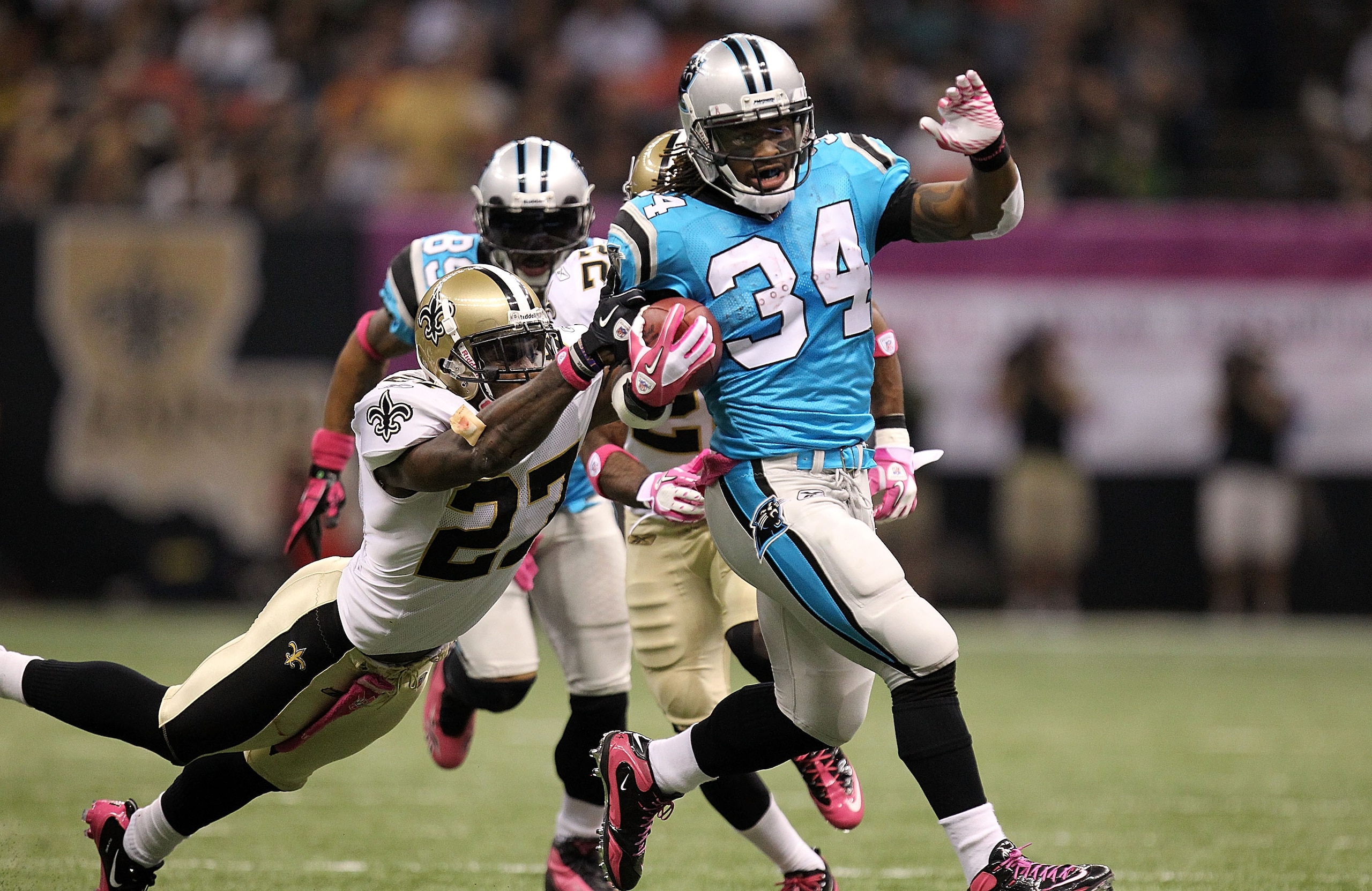 NEW ORLEANS - OCTOBER 03:  Running back DeAngelo Williams #34 of the Carolina Panthers runs for a touchdown past Malcolm Jenkins #27 of the New Orleans Saints at the Louisiana Superdome on October 3, 2010 in New Orleans, Louisiana.  (Photo by Ronald Marti
