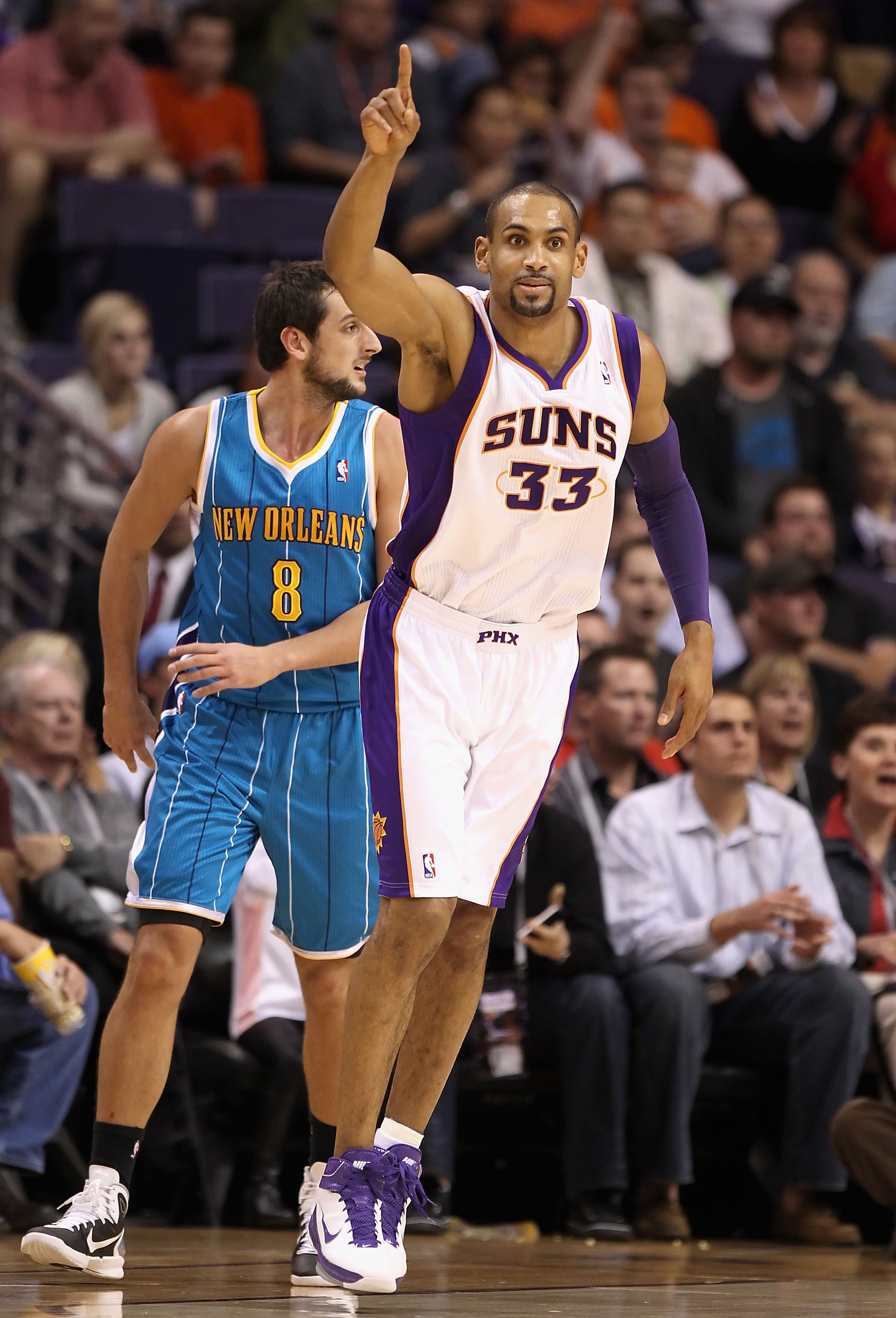 PHOENIX, AZ - JANUARY 30:  Grant Hill #33 of the Phoenix Suns reacts after hitting a three point shot past Marco Belinelli #8 of the New Orleans Hornets during the NBA game at US Airways Center on January 30, 2011 in Phoenix, Arizona.  The Suns defeated t
