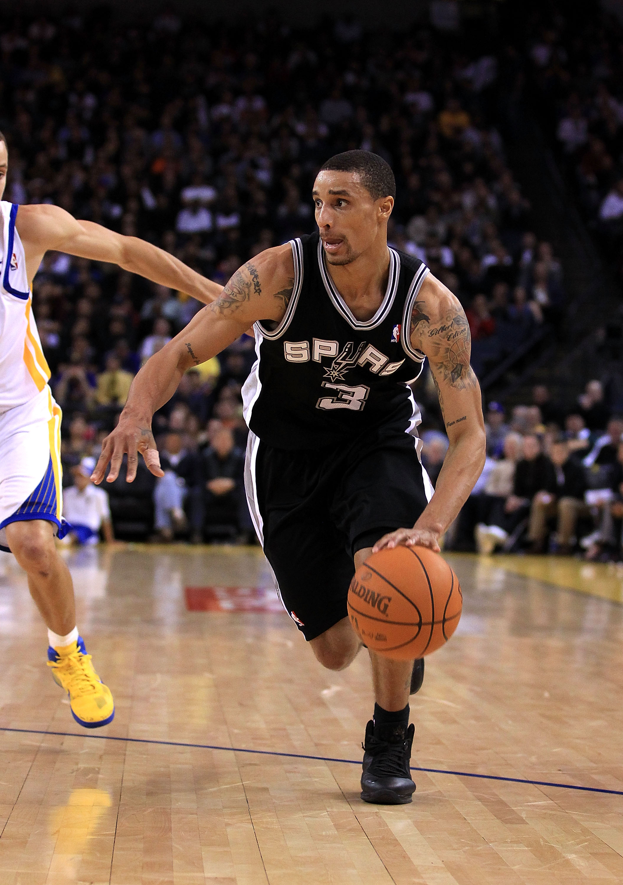 OAKLAND, CA - JANUARY 24:  George Hill #3 of the San Antonio Spurs in action against the Golden State Warriors at Oracle Arena on January 24, 2011 in Oakland, California.  NOTE TO USER: User expressly acknowledges and agrees that, by downloading and or us