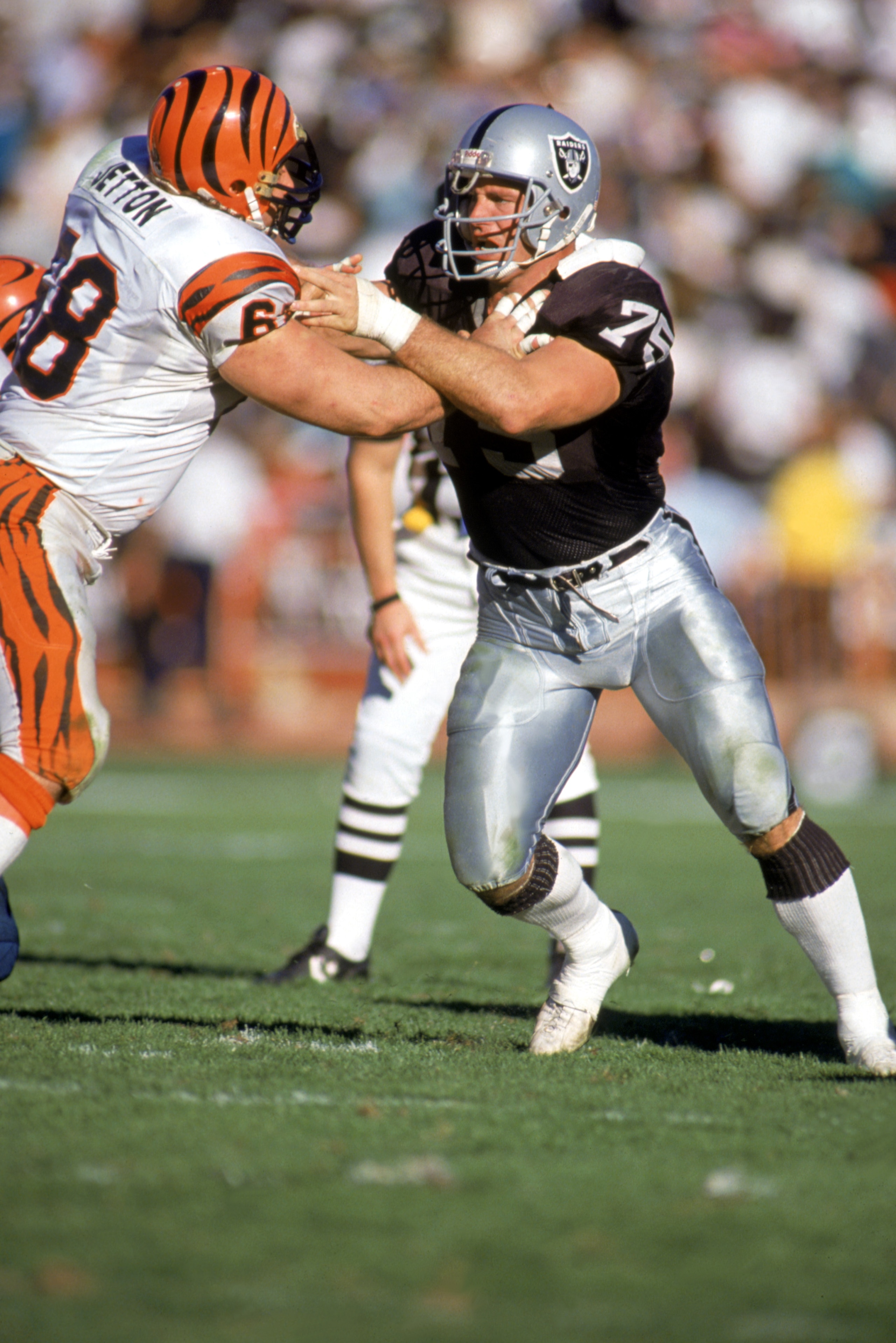 LOS ANGELES - JANUARY 13:  Defensive lineman Howie Long #75 of the Los Angeles Raiders is blocked during a playoff game against the Cincinnati Bengals at the L.A. Coliseum on January 13, 1991 in Los Angeles, California.  The Raiders defeated the Bengals 2