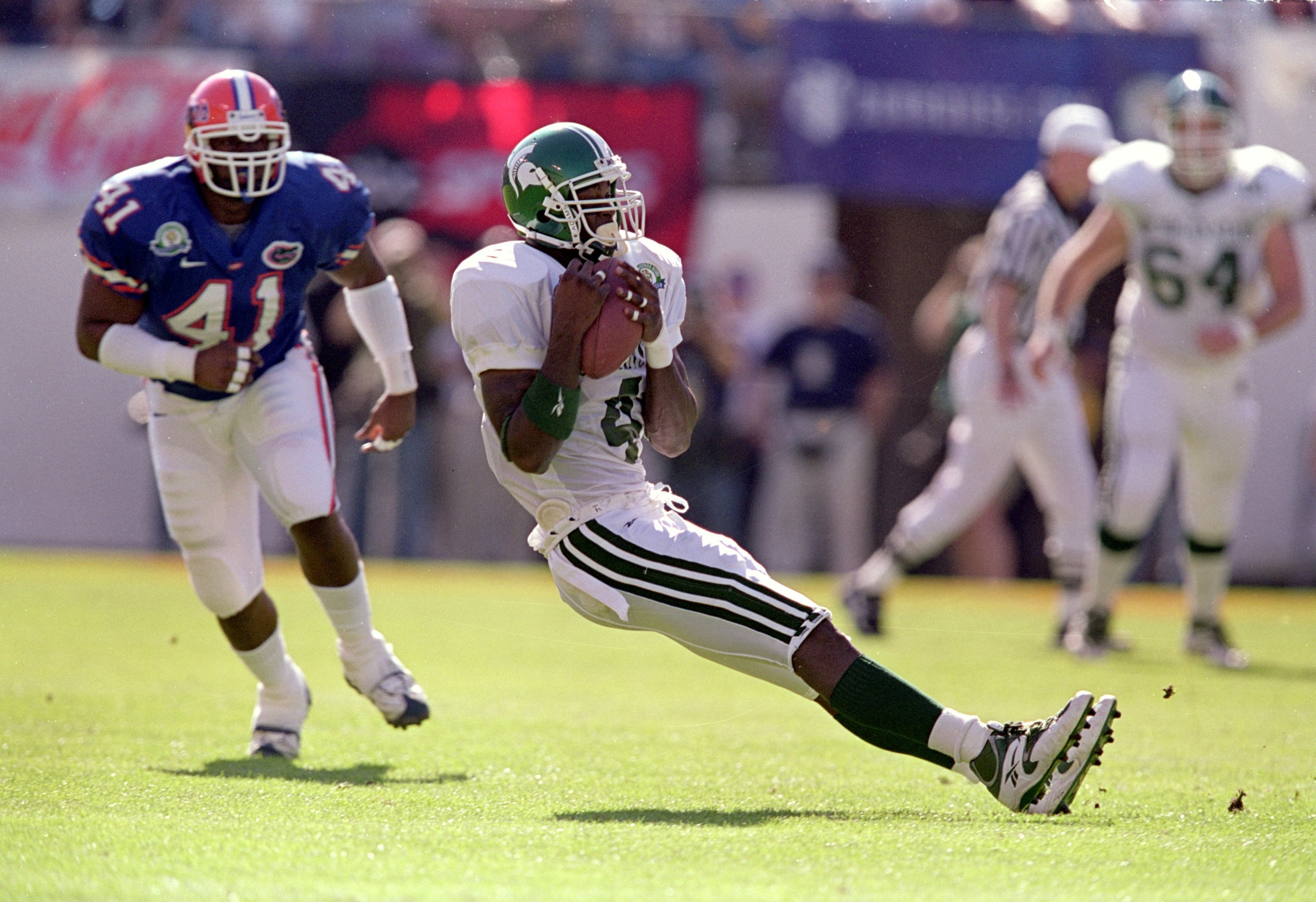 1 Jan 2000:  Plaxico Burress #4 of the Michigan State Spartans slids to the ground with the ball during the Citrus Bowl Game against the Florida Gators at the Citrus Bowl in Orlando, Florida. The Spartans deafeated the Gotors 37-34. Mandatory Credit: Andy