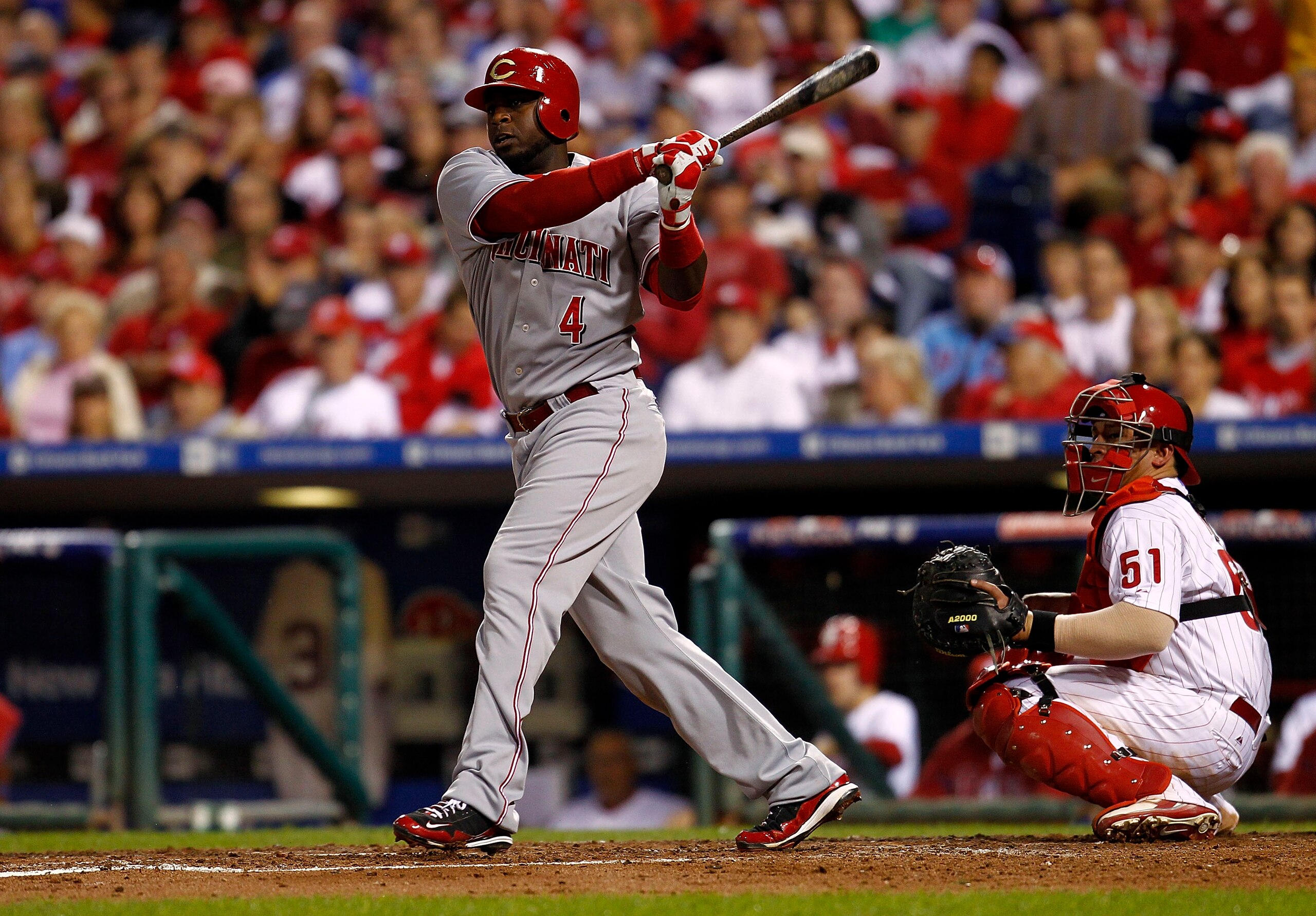 PHILADELPHIA - OCTOBER 08: Brandon Phillips #4 of the Cincinnati Reds doubles in Game 2 of the NLDS in front of Carlos Ruiz #51 of the Philadelphia Phillies at Citizens Bank Park on October 8, 2010 in Philadelphia, Pennsylvania. (Photo by Jeff Zelevansk PHILADELPHIA - OCTOBER 08: Brandon Phillips #4 of the Cincinnati Reds doubles in Game 2 of the NLDS in front of Carlos Ruiz #51 of the Philadelphia Phillies at Citizens Bank Park on October 8, 2010 in Philadelphia, Pennsylvania. (Photo by Jeff Zelevansk