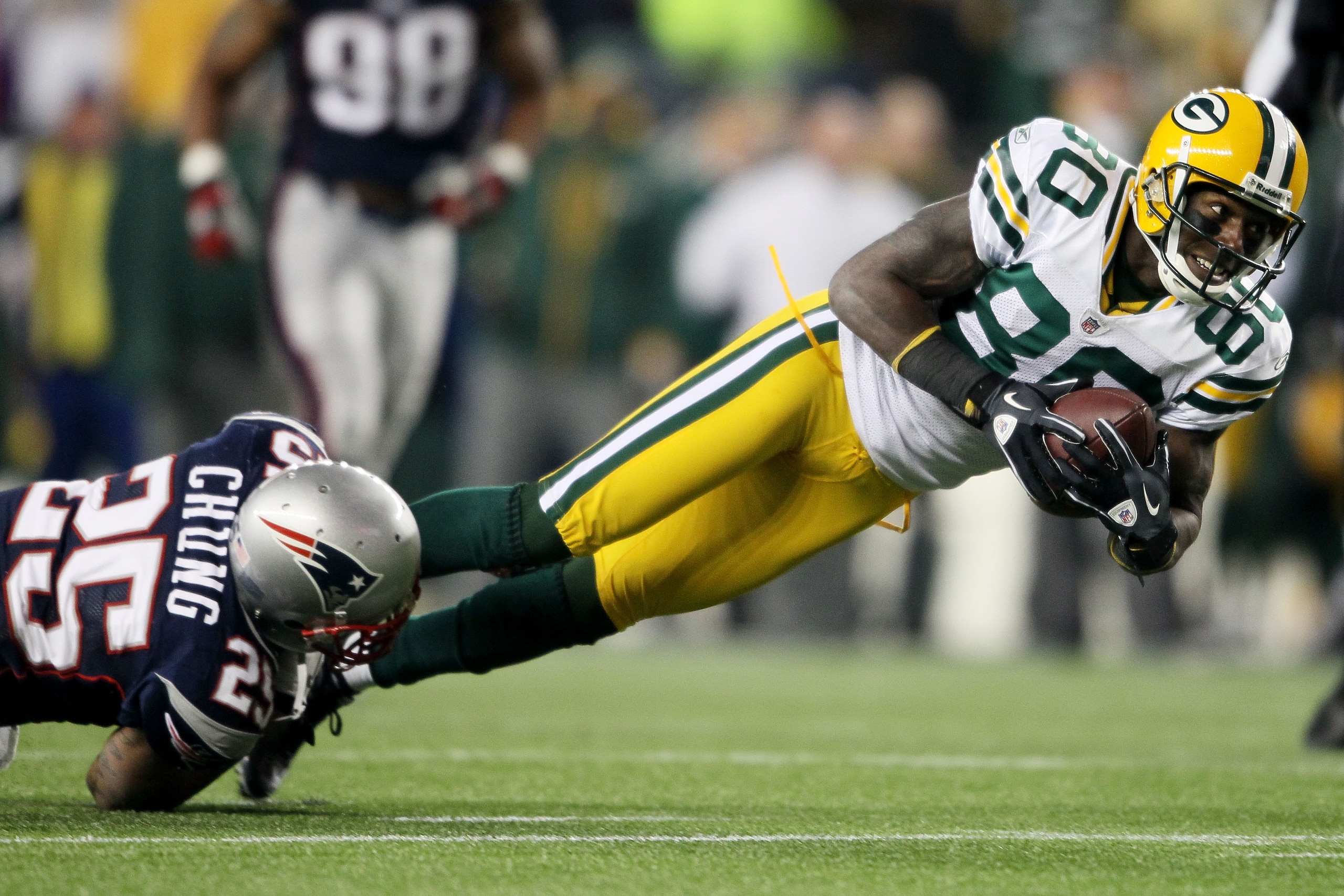 FOXBORO, MA - DECEMBER 19:  Safety Patrick Chung #25 of the New England Patriots tackles wide receiver Donald Driver #80 of the Green Bay Packers during the fourth quarter of the game at Gillette Stadium on December 19, 2010 in Foxboro, Massachusetts. The