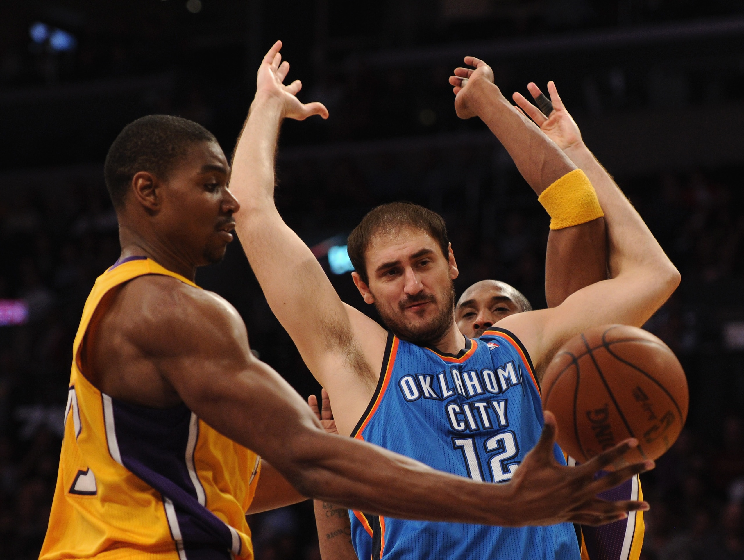 LOS ANGELES, CA - JANUARY 17:  Nenad Krstic #12 of the Oklahoma City Thunder is fouled by Kobe Bryant #24 Los Angeles Lakers as Andrew Bynum #17 takes the ball during a 101-94 Laker win at the Staples Center on January 17, 2011 in Los Angeles, California.