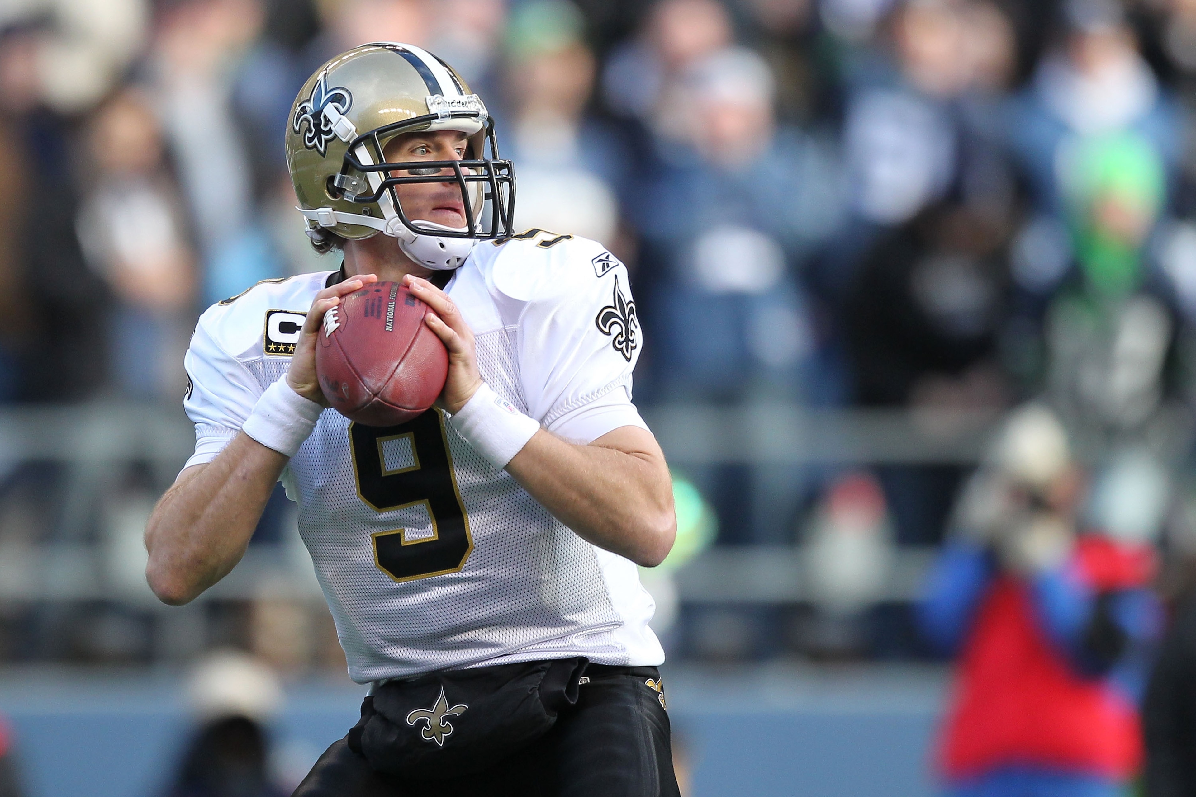 SEATTLE, WA - JANUARY 08: Quarterback Drew Brees #9 of the New Orleans Saints scrambles against the Seattle Seahawks during the 2011 NFC wild-card playoff game at Qwest Field on January 8, 2011 in Seattle, Washington. (Photo by Otto Greule Jr/Getty Imag SEATTLE, WA - JANUARY 08: Quarterback Drew Brees #9 of the New Orleans Saints scrambles against the Seattle Seahawks during the 2011 NFC wild-card playoff game at Qwest Field on January 8, 2011 in Seattle, Washington. (Photo by Otto Greule Jr/Getty Imag