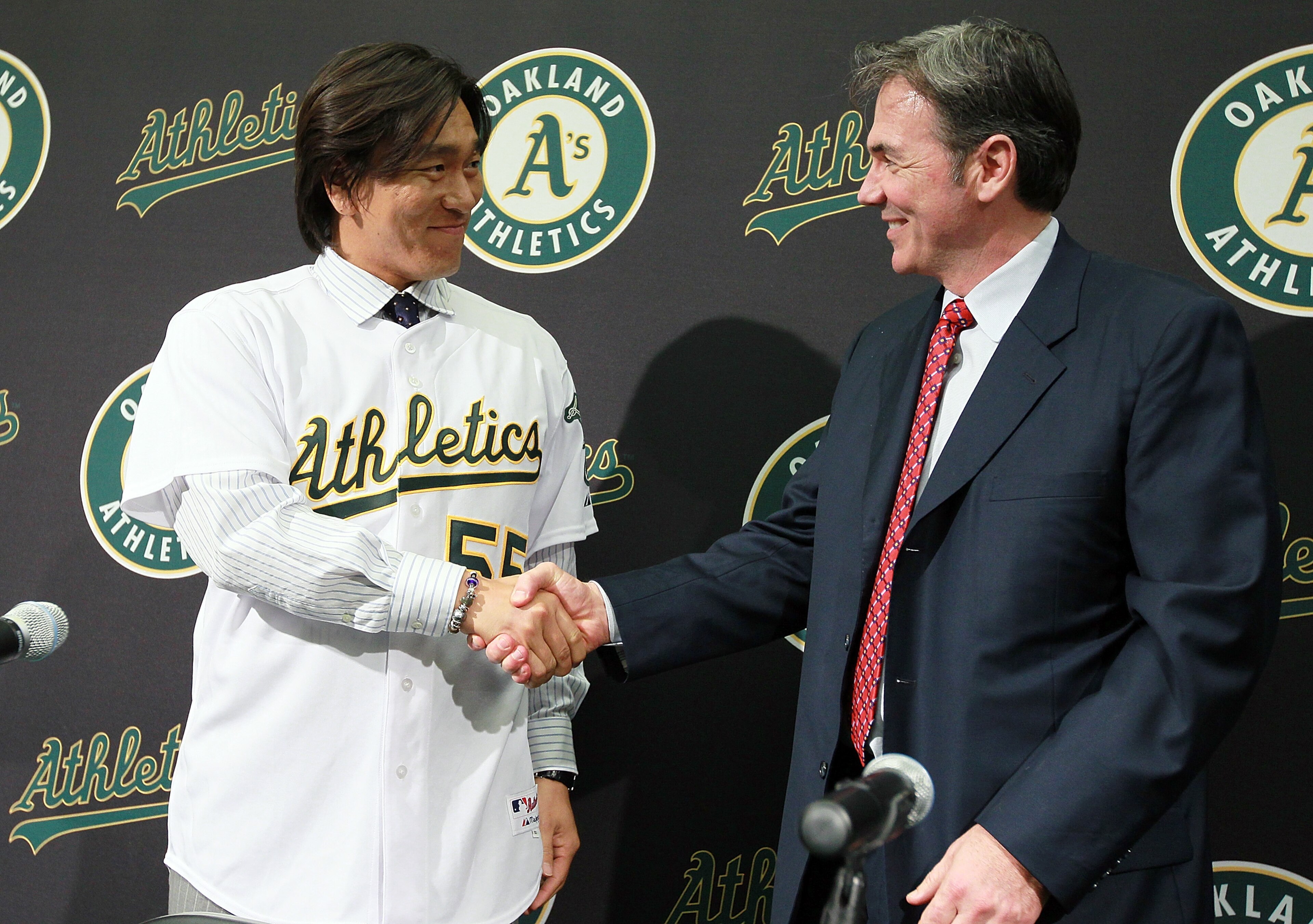 OAKLAND, CA - DECEMBER 14: Hideki Matsui (L) shakes hands with Oakland Athletics general manager Billy Beane (R) after trying on his new jersey during a press conference where he was introduced as the newest member of the Oakland Athletics at Oakland-Ala OAKLAND, CA - DECEMBER 14: Hideki Matsui (L) shakes hands with Oakland Athletics general manager Billy Beane (R) after trying on his new jersey during a press conference where he was introduced as the newest member of the Oakland Athletics at Oakland-Ala