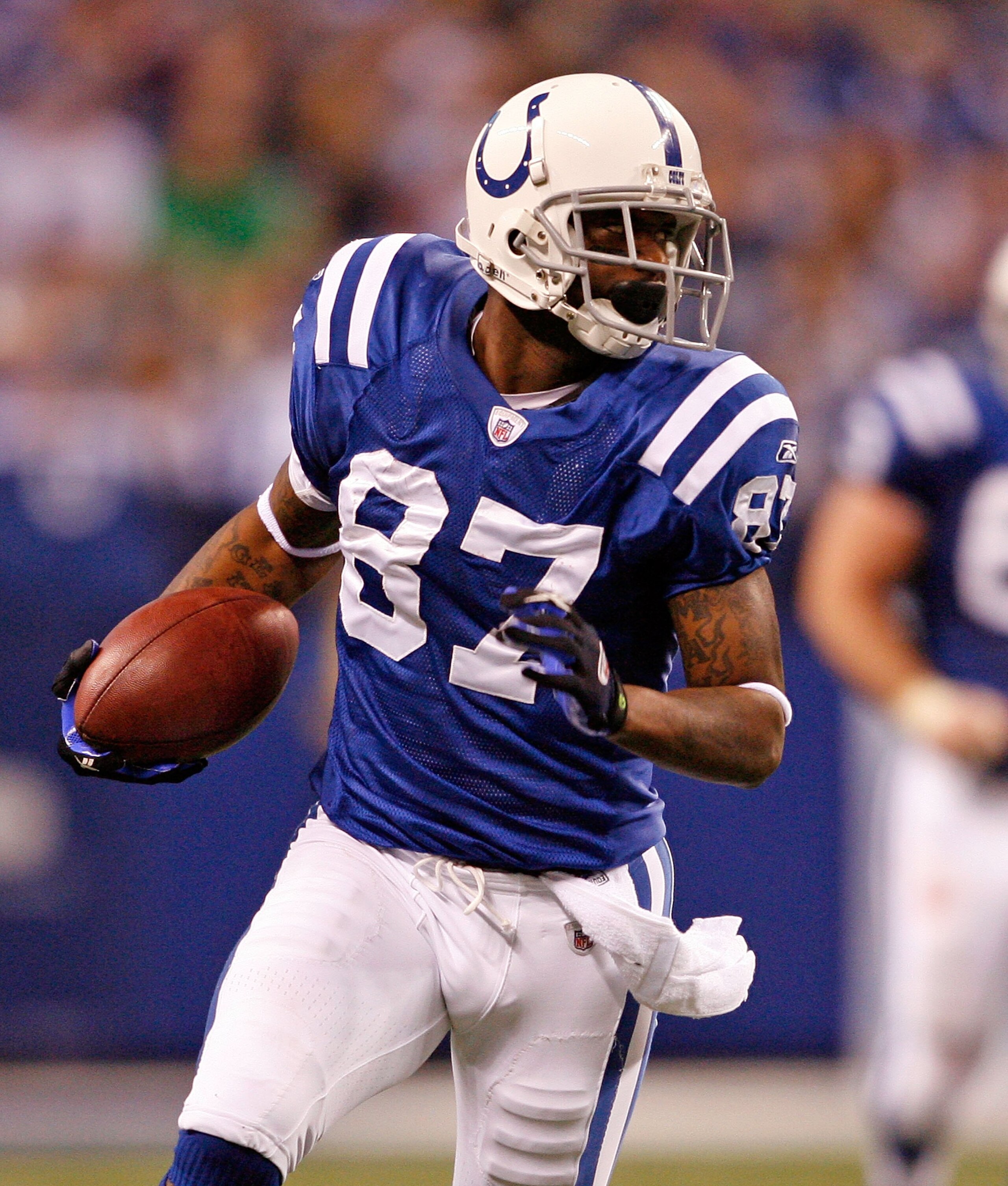 INDIANAPOLIS - DECEMBER 13:  Reggie Wayne #85 of the Indianapolis Colts runs with the ball during the NFL game against the Denver Broncos at Lucas Oil Stadium on December 13, 2009 in Indianapolis, Indiana.  (Photo by Andy Lyons/Getty Images)