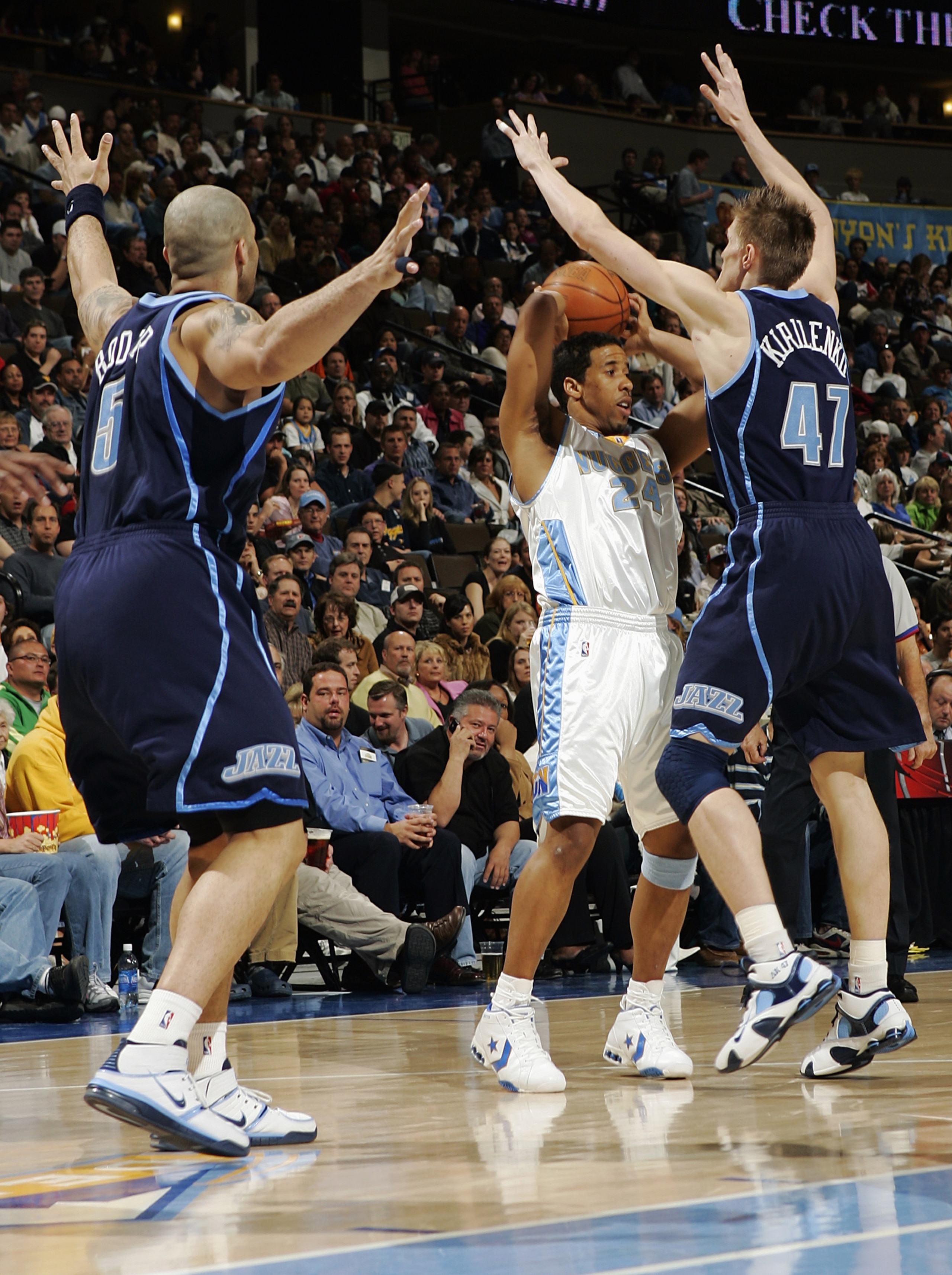 DENVER - MARCH 29:  Andre Miller #24 of the Denver Nuggets looks to pass under pressure by Andrei Kirilenko #47 and Carlos Boozer #5 of the Utah Jazz on March 29, 2006 at the Pepsi Center in Denver, Colorado. The Jazz won 115-104. NOTE TO USER: USER expre
