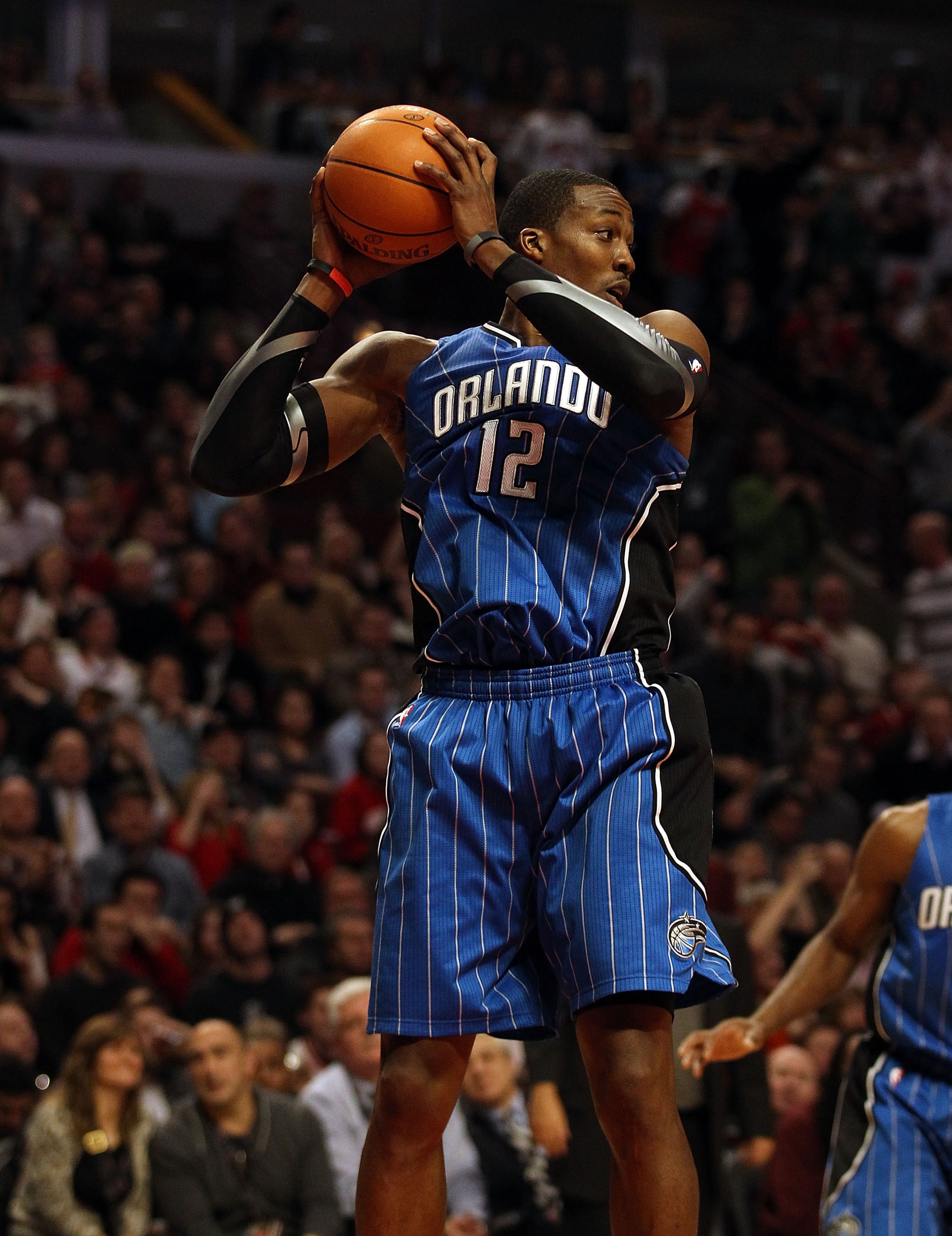 CHICAGO, IL - JANUARY 28: Dwight Howard #12 of the Orlando Magic grabs a rebound against the Chicago Bulls at the United Center on January 28, 2011 in Chicago, Illinois. The Bulls defeated the Magic 99-90. NOTE TO USER: User expressly acknowledges and agr