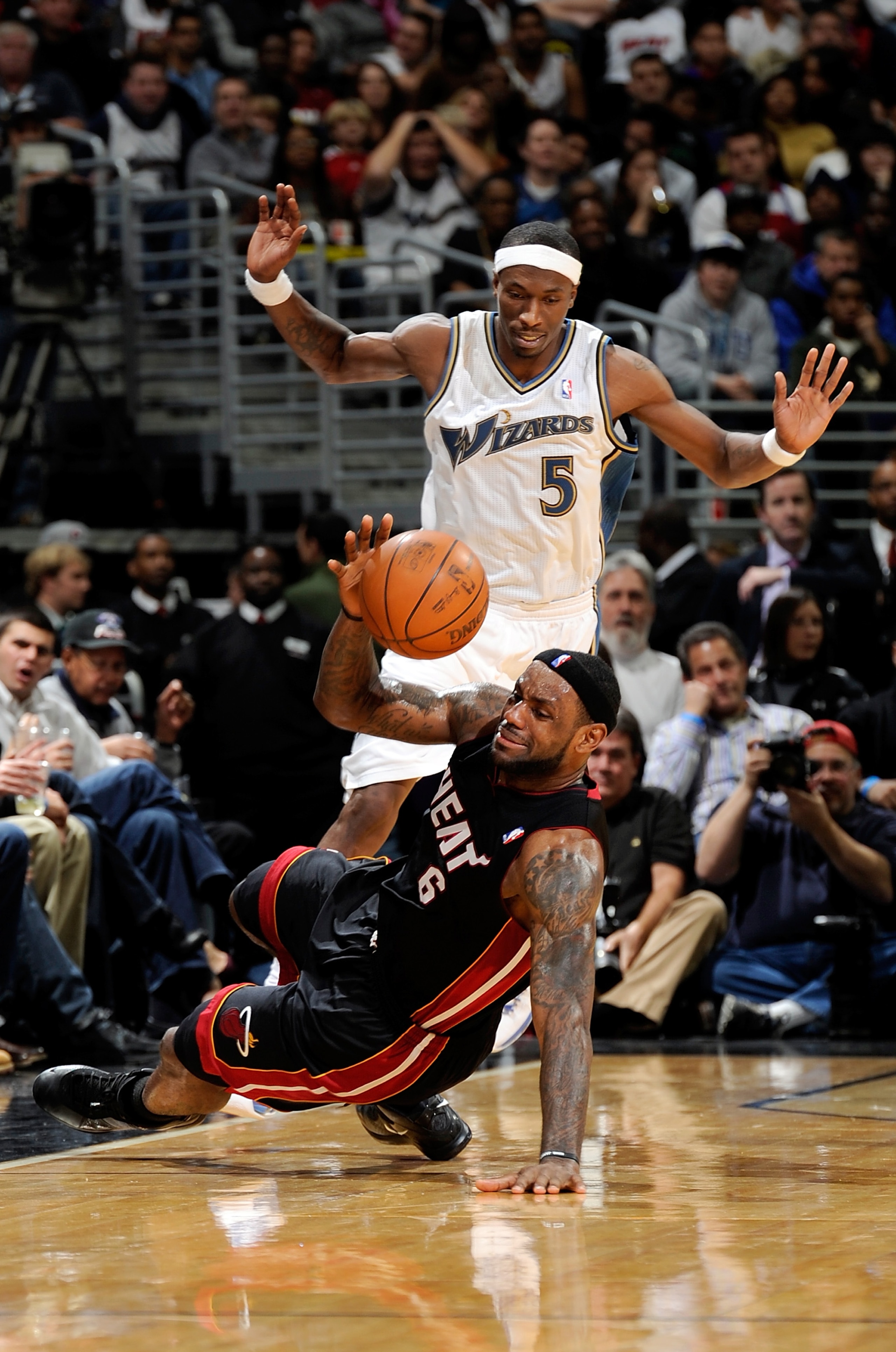 WASHINGTON - DECEMBER 18:  LeBron James #6 of the Miami Heat is fouled by Josh Howard #5 of the Washington Wizards at the Verizon Center on December 18, 2010 in Washington, DC. NOTE TO USER: User expressly acknowledges and agrees that, by downloading and