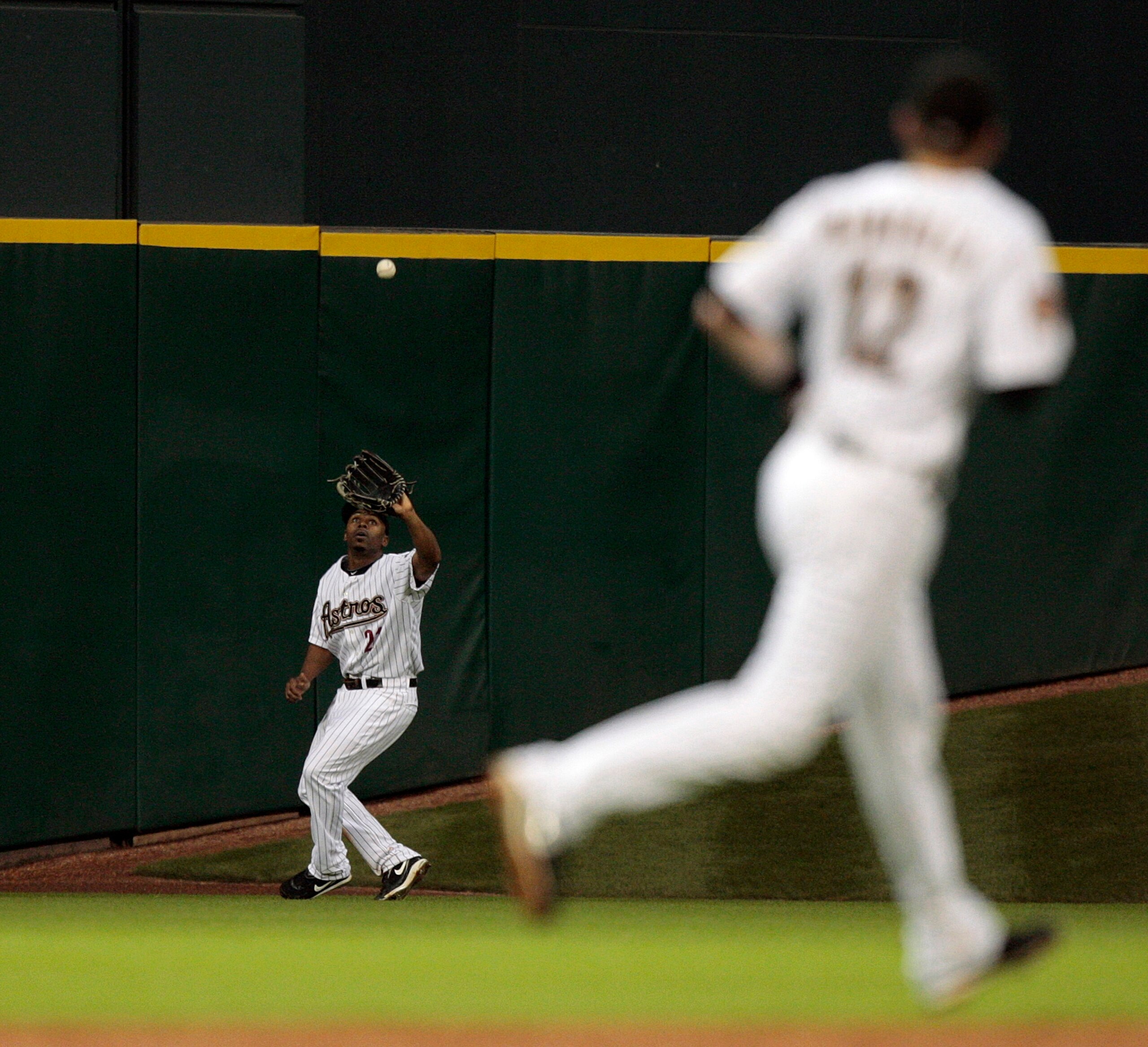 HOUSTON - AUGUST 31: Center fielder Michael Bourn #21 of the Houston Astros catches a deep fly ball during a baseball game against the St. Louis Cardinals at Minute Maid Park on August 31, 2010 in Houston, Texas. (Photo by Bob Levey/Getty Images) HOUSTON - AUGUST 31: Center fielder Michael Bourn #21 of the Houston Astros catches a deep fly ball during a baseball game against the St. Louis Cardinals at Minute Maid Park on August 31, 2010 in Houston, Texas. (Photo by Bob Levey/Getty Images)