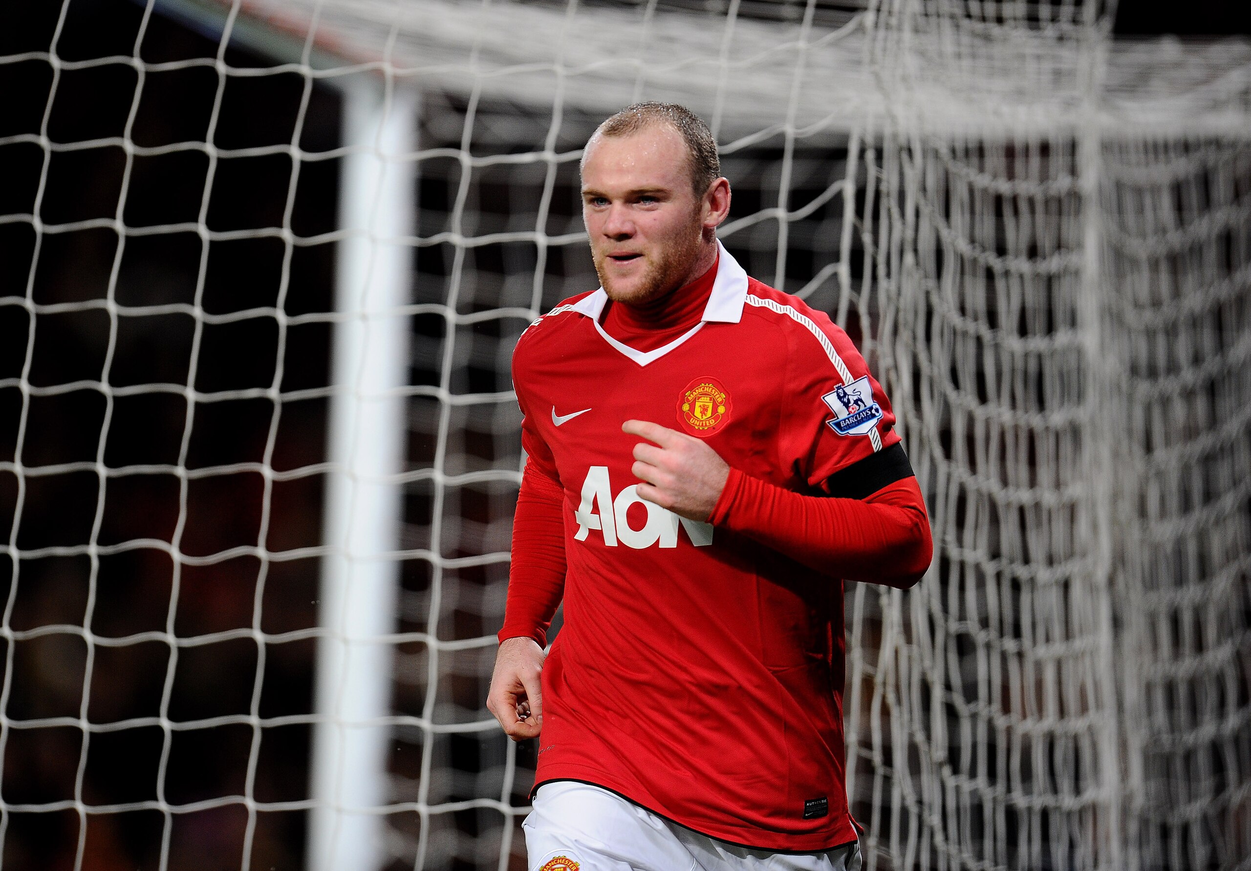 MANCHESTER, ENGLAND - FEBRUARY 01:  Wayne Rooney of Manchester United runs behind the net after scoring his team's second goal during the Barclays Premier League match between Manchester United and Aston Villa at Old Trafford on February 1, 2011 in Manche