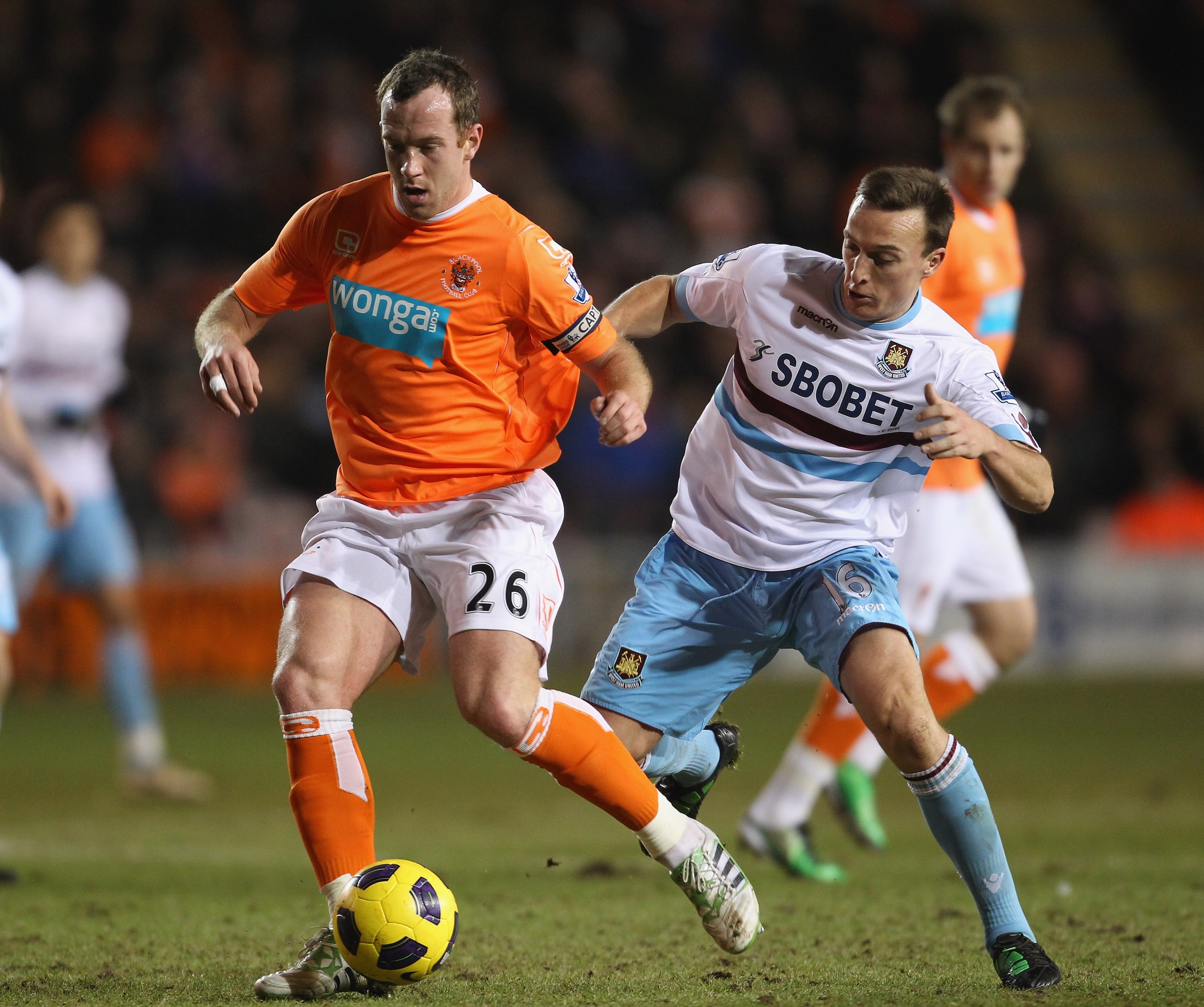 BLACKPOOL, ENGLAND - FEBRUARY 02:  Charlie Adam of Blackpool holds off a challenge from Mark Noble of West Ham United during the Barclays Premier League match between Blackpool and West Ham United at Bloomfield Road on February 2, 2011 in Blackpool, Engla