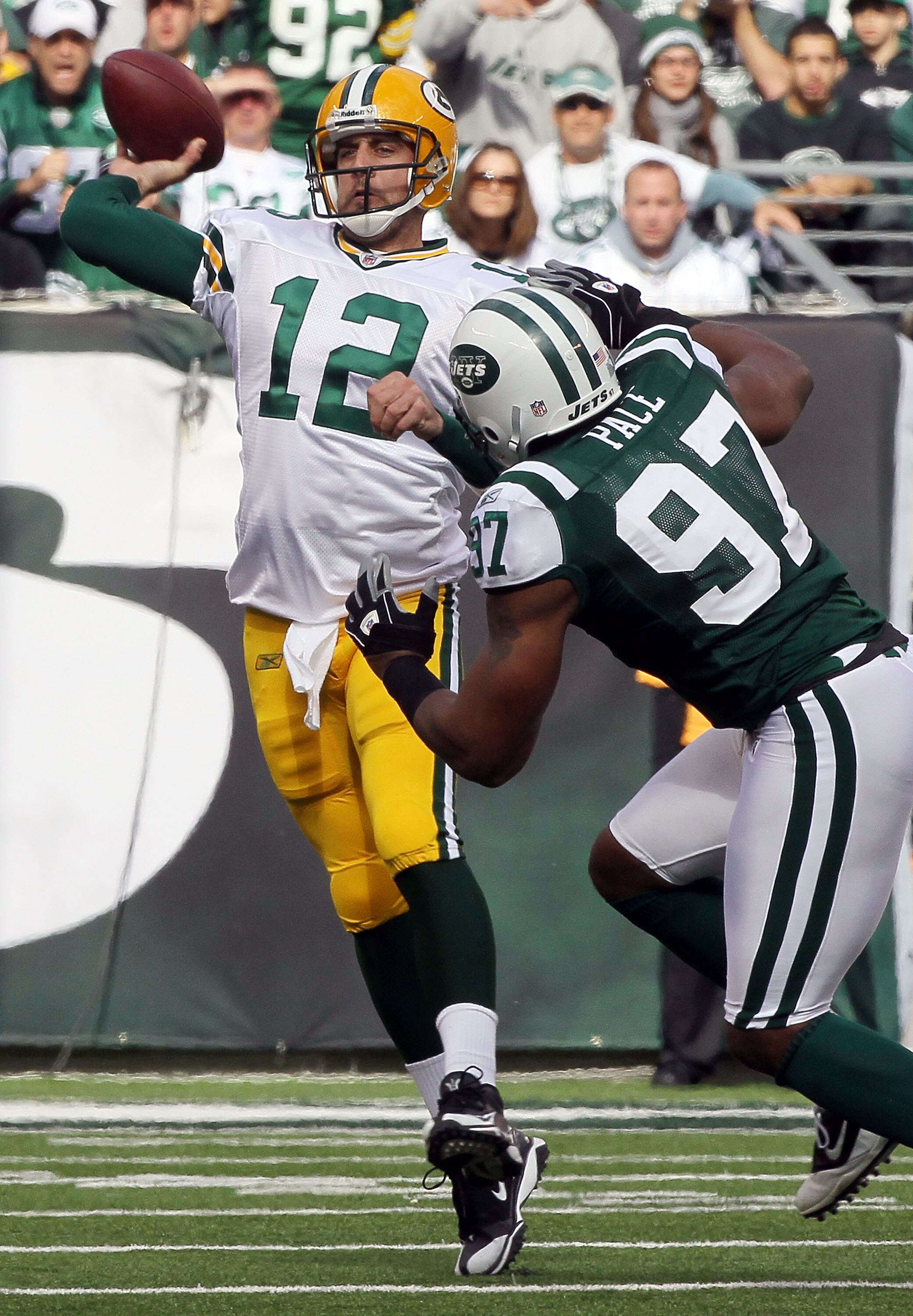 EAST RUTHERFORD, NJ - OCTOBER 31: Aaron Rodgers #12 of the Green Bay Packers throws a pass under pressure from Calvin Pace #97 of the New York Jets on October 31, 2010 at the New Meadowlands Stadium in East Rutherford, New Jersey. (Photo by Jim McIsaac/Ge