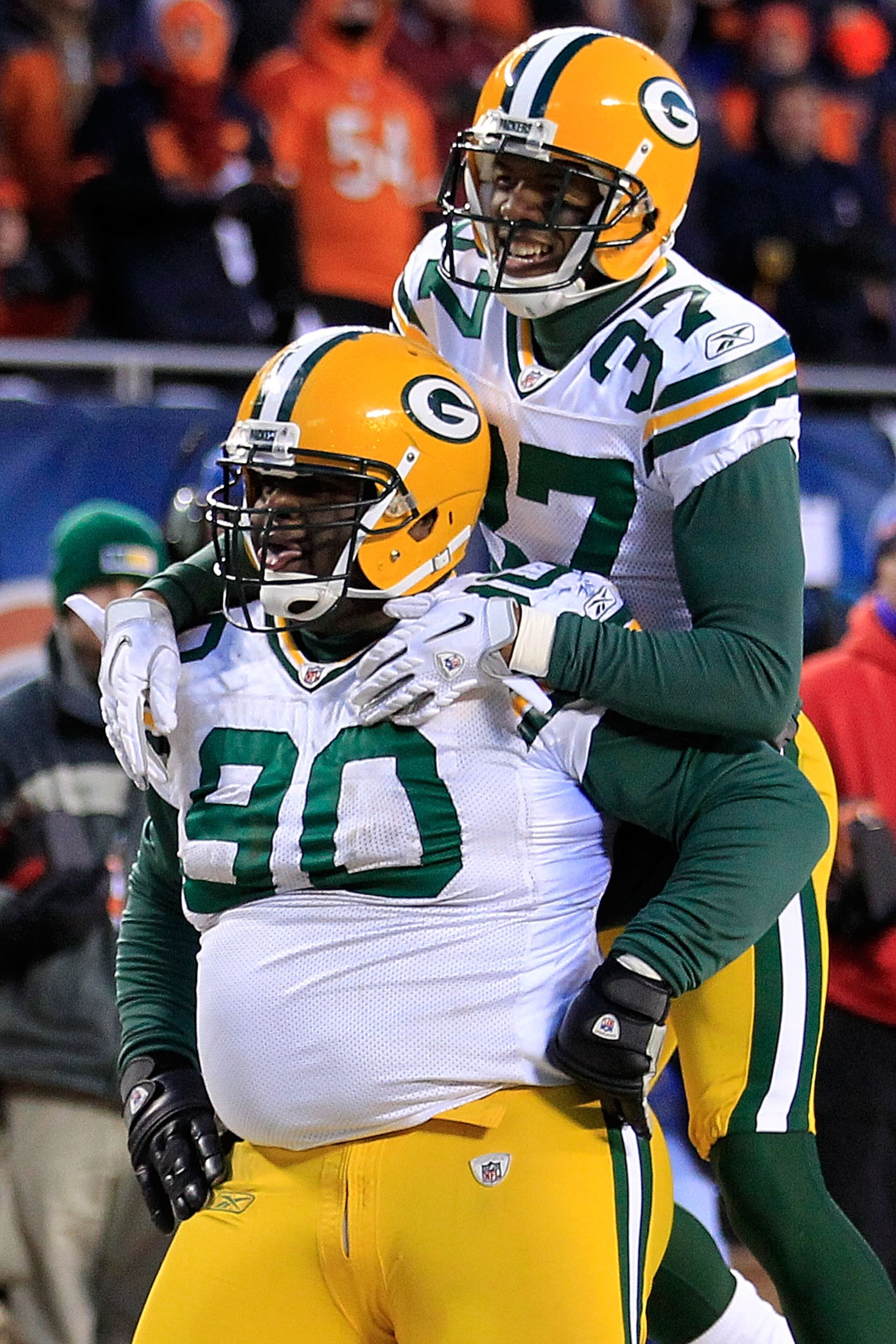 CHICAGO, IL - JANUARY 23: B.J. Raji #90 of the Green Bay Packers reacts with teammate Sam Shields #37 after scoring on a 18-yard interception return for a touchdown in the fourth quarter against the Chicago Bears in the NFC Championship Game at Soldier F CHICAGO, IL - JANUARY 23: B.J. Raji #90 of the Green Bay Packers reacts with teammate Sam Shields #37 after scoring on a 18-yard interception return for a touchdown in the fourth quarter against the Chicago Bears in the NFC Championship Game at Soldier F