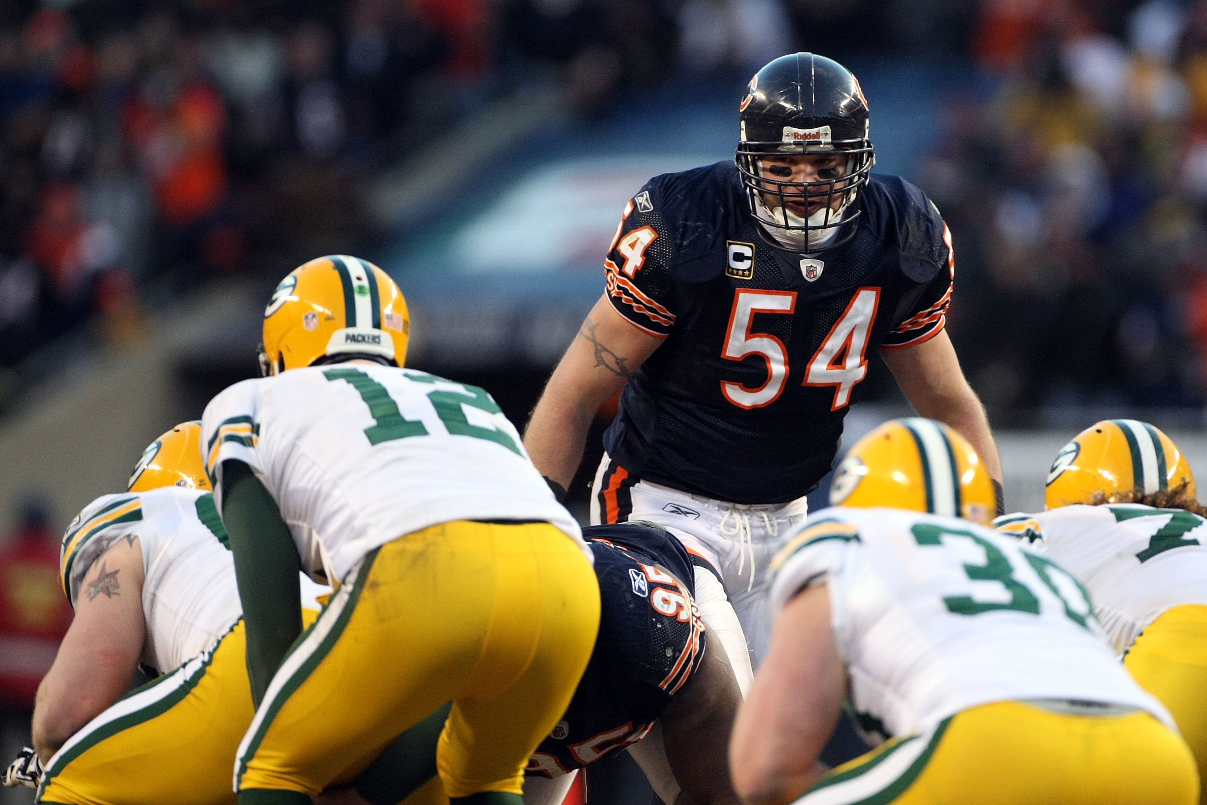 CHICAGO, IL - JANUARY 23: Brian Urlacher #54 of the Chicago Bears looks over at Aaron Rodgers #12 of the Green Bay Packers before the snap in the NFC Championship Game at Soldier Field on January 23, 2011 in Chicago, Illinois. (Photo by Doug Pensinger/G CHICAGO, IL - JANUARY 23: Brian Urlacher #54 of the Chicago Bears looks over at Aaron Rodgers #12 of the Green Bay Packers before the snap in the NFC Championship Game at Soldier Field on January 23, 2011 in Chicago, Illinois. (Photo by Doug Pensinger/G